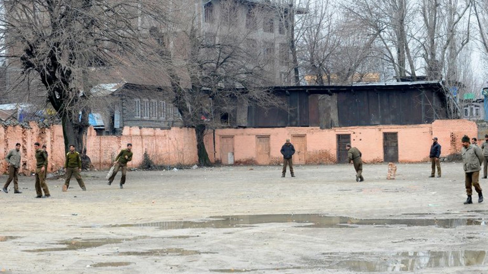 Policemen play cricket during a strike in Srinagar, Kashmir in February. Parvez Rasool on Friday became the first Kashmiri cricketer to be selected for India after he was named for a limited-overs series against Zimbabwe later this month.