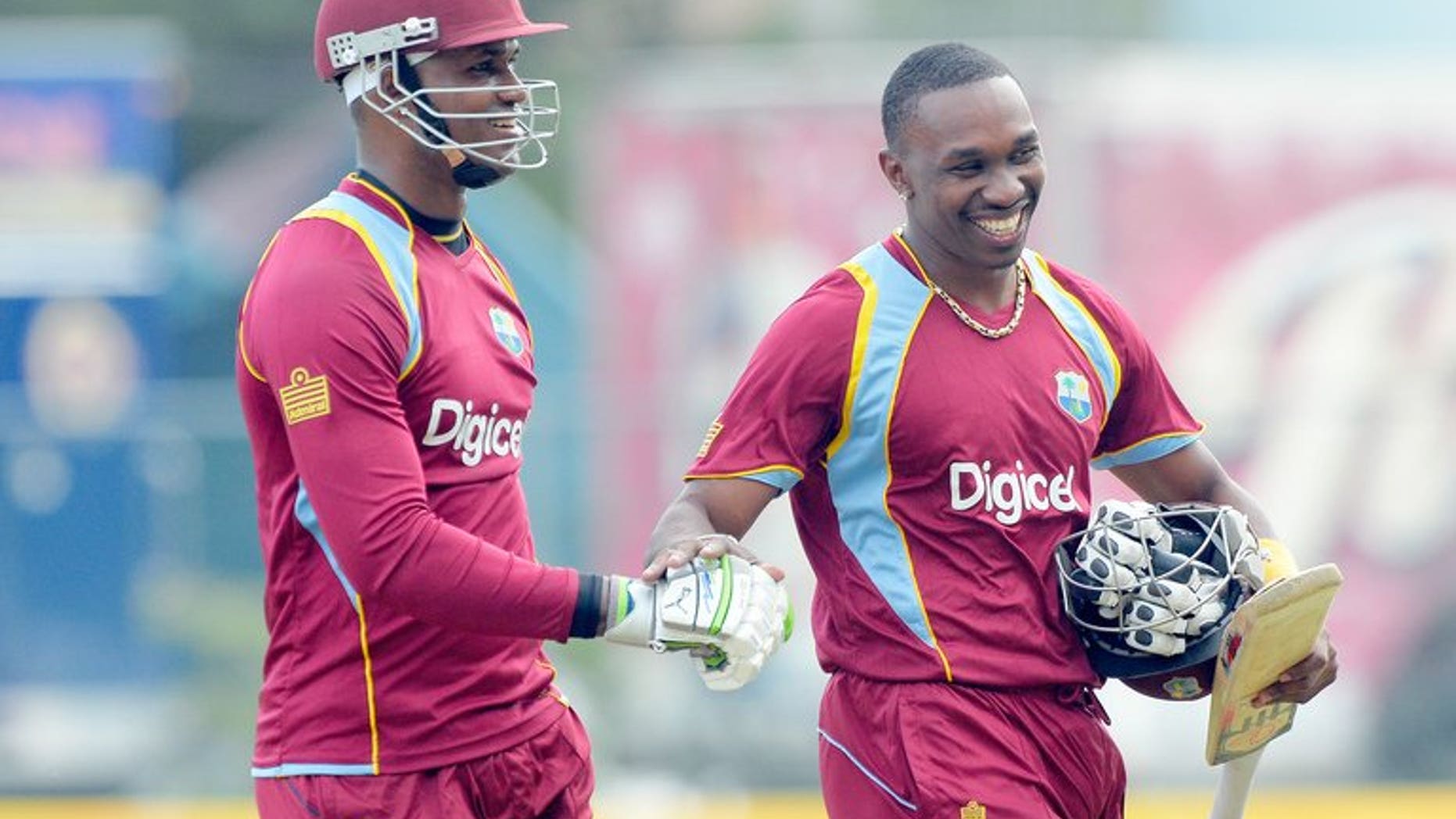Dwayne Bravo (right) and Marlon Samuels leave the field after West Indies beat Sri Lanka in Kingston on June 28. West Indies captain Dwayne Bravo won the toss and put India in to bat in the fourth match of the Celkon Mobile Cup Tri-Nation Series at Queen's Park Oval on Friday.