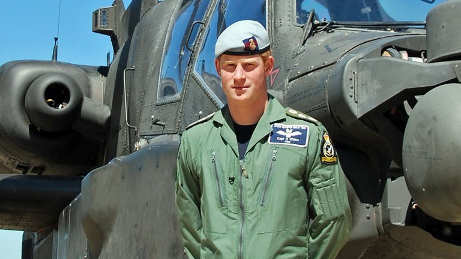 Captain Harry Wales, Britain's Prince Harry poses for a photograph beside an Apache helicopter at an undisclosed location, in an undated picture. Prince Harry has qualified as an Apache helicopter commander, the Ministry of Defence announced Friday, putting him in charge of the aircraft he co-piloted in Afghanistan.