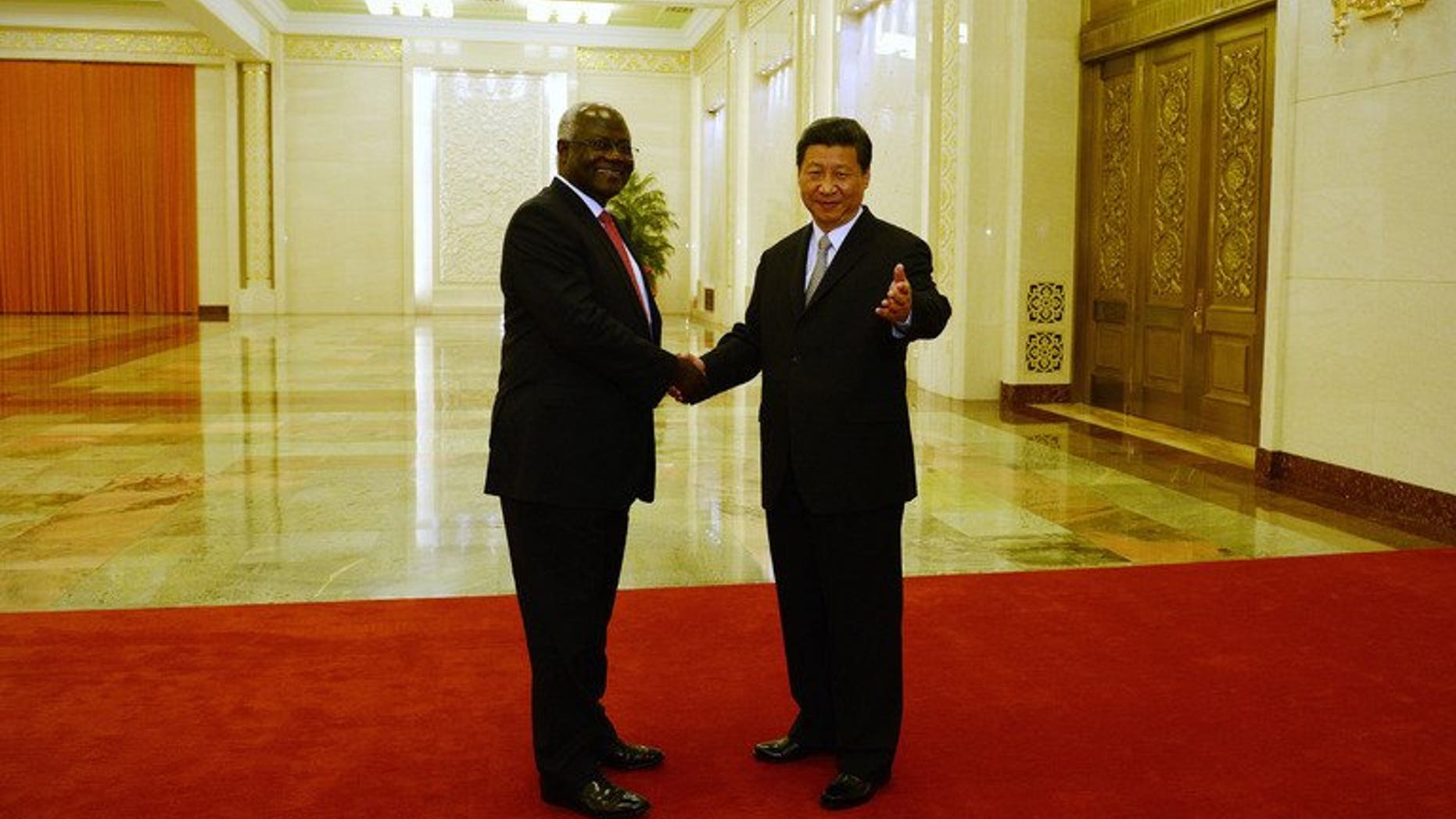 Sierra Leonean President Ernest Bai Koroma (L) meets with Chinese President Xi Jinping (R) at the Great Hall of the People in Beijing on June 26, 2013. Koroma said on Friday that he had signed deals for a new international airport, a railway and raft of other huge construction projects totalling $8 billion during a recent visit to China.