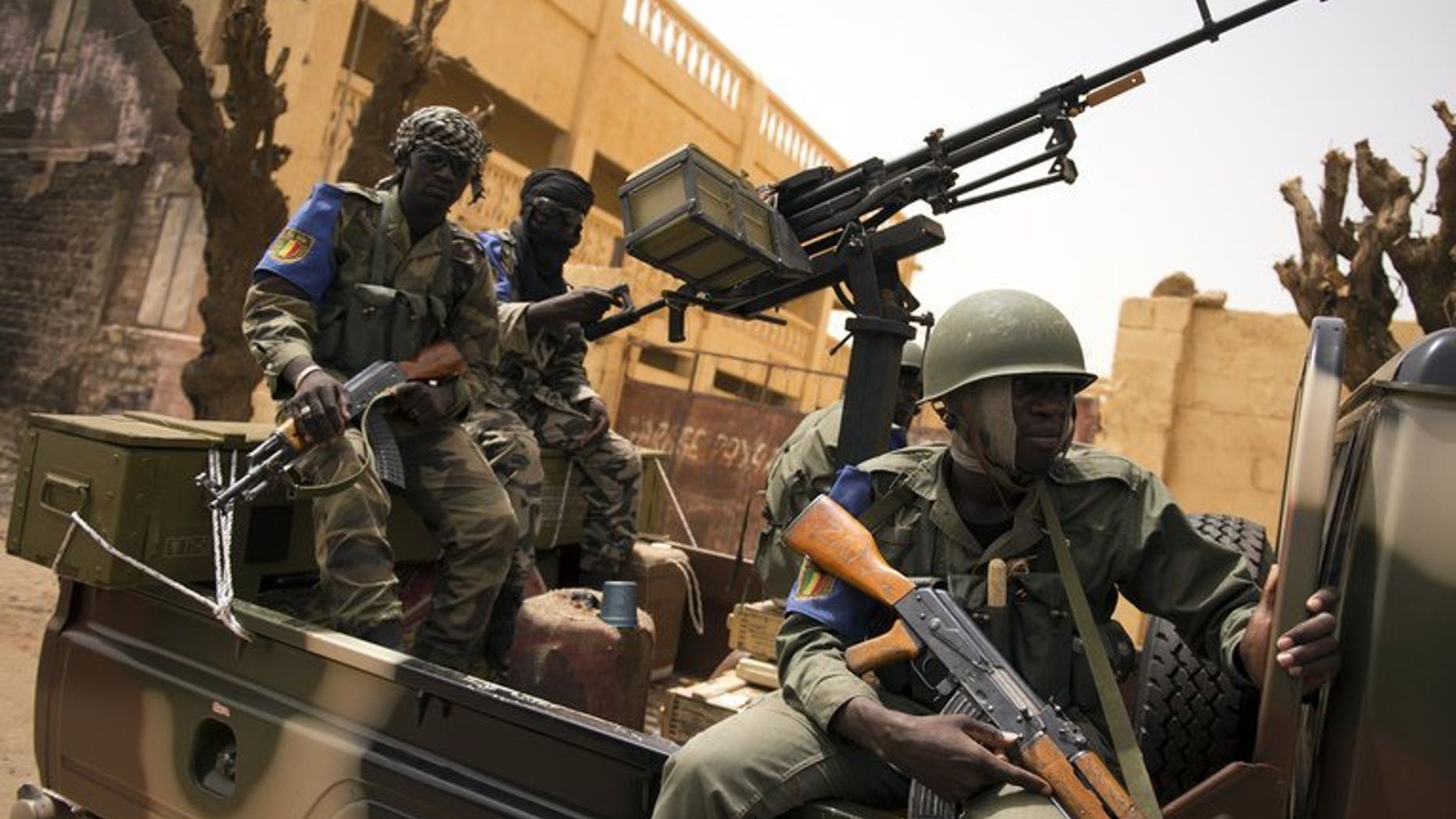 Malian soldiers patrol in the streets of Gao on June 13, 2013. Mali has lifted a five-month state of emergency, on the eve of the start of a presidential election campaign for July 28 polls in the troubled west African nation.
