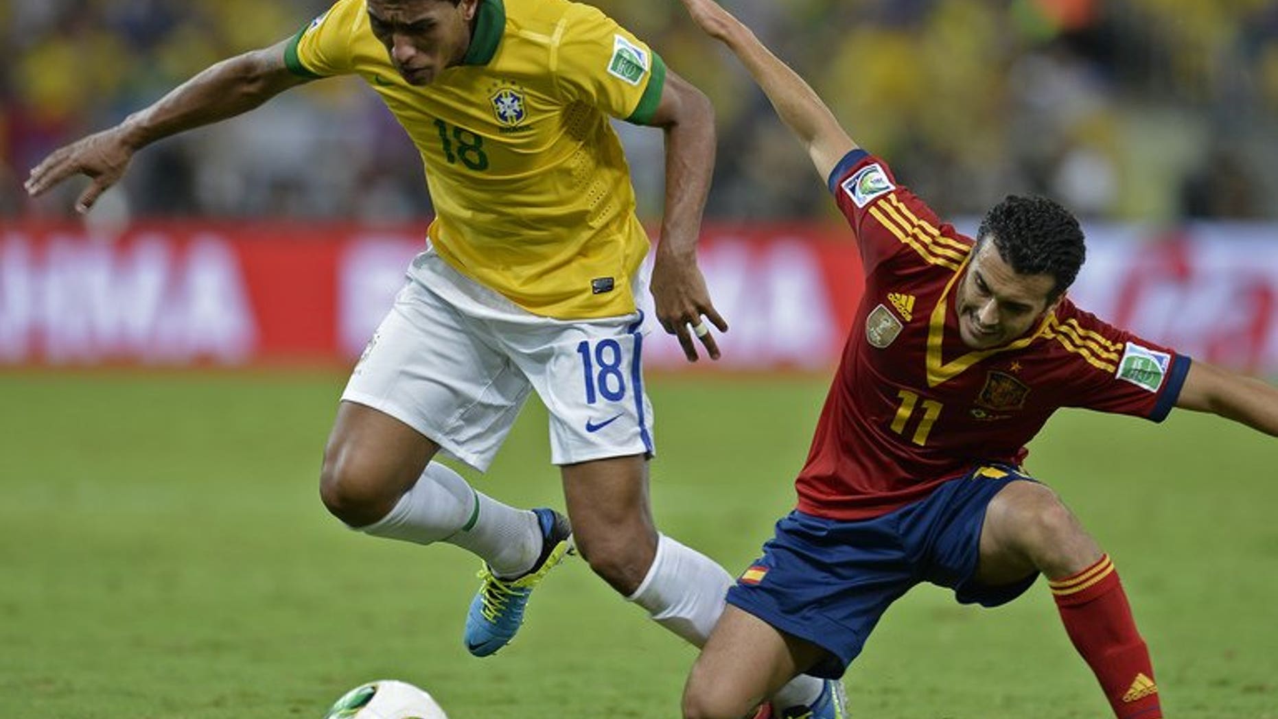 Paulinho (left) clashes with Pedro Rodriguez during the Confederation Cup final in Rio de Janeiro last Sunday. Paulinho joined Tottenham Hotspur on Saturday as the English Premier League club made their first pre-season signing in a bid to secure a top four finish next term.