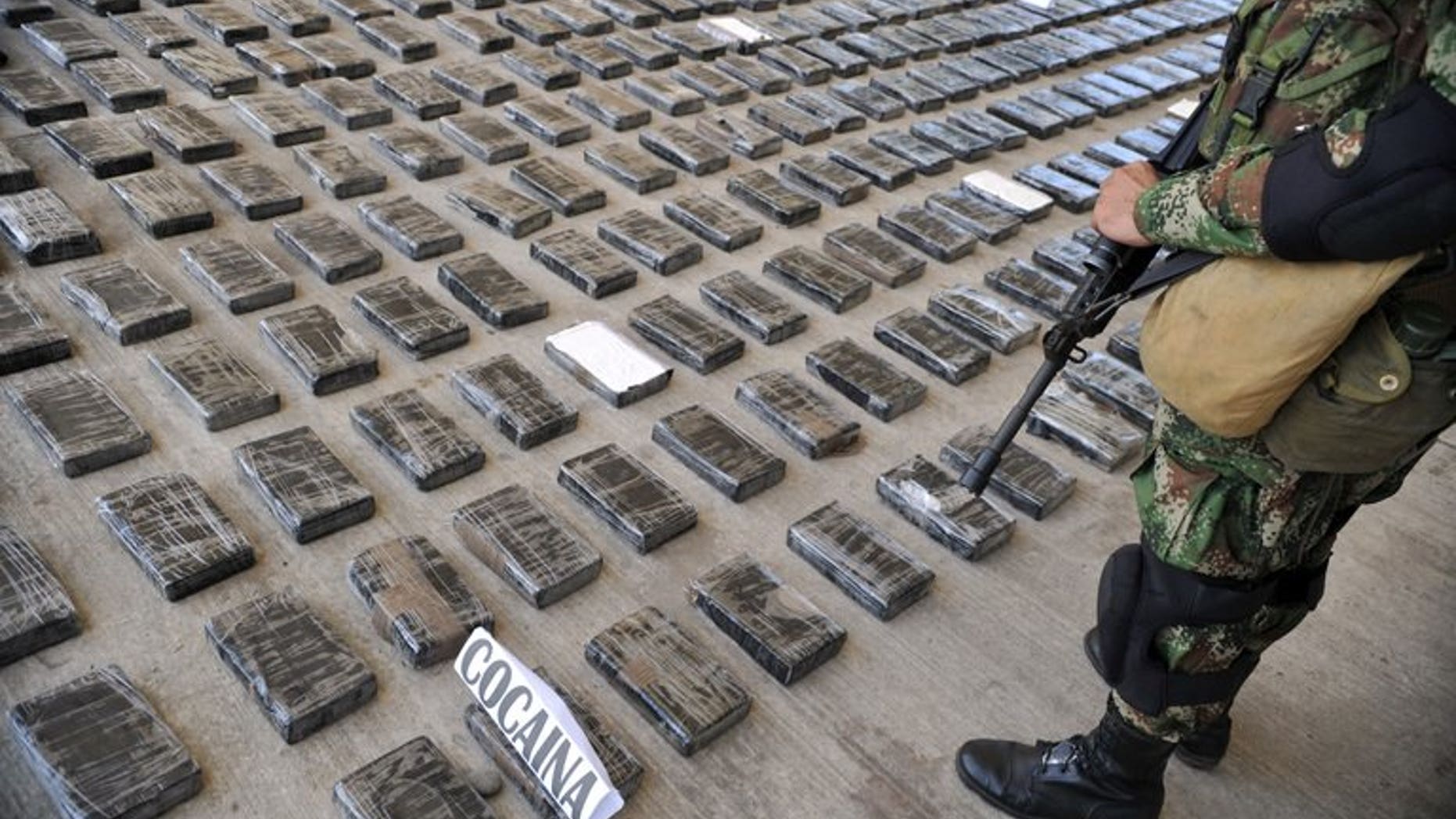A soldier guards a huge shipment of cocaine seized in a clandestine laboratory, on March 16, 2013, in Tumaco, Colombia. An Italian mafia capo alleged to be the biggest cocaine trafficker in the world will be deported to Italy, a day after being arrested in a Colombian shopping mall, prosecutors said.