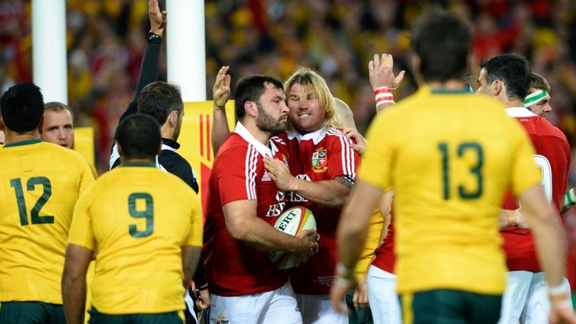 Alex Corbisiero (centre L) is congratulated by Richard Hibbard (centre R) after scoring a try in Sydney on Saturday.