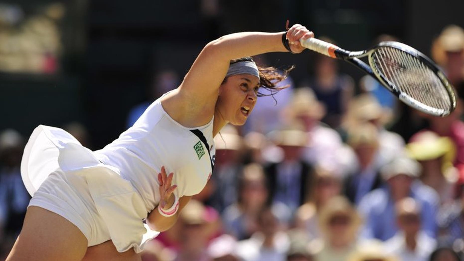 Marion Bartoli serves against Sabine Lisicki at Wimbledon on Saturday. Marion Bartoli romped to her first Grand Slam title as the French 15th seed thrashed Germany's Sabine Lisicki 6-1, 6-4 in the Wimbledon final on Saturday.
