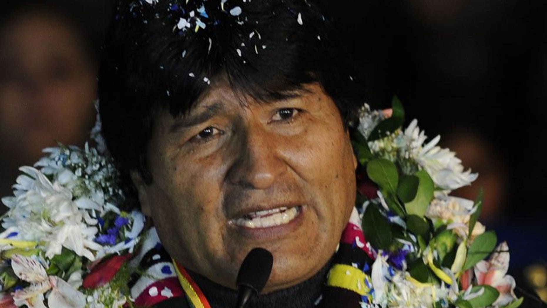 Evo Morales speaks to journalists at El Alto Airport late July 3, 2013 in La Paz. The Bolivian President says he would grant asylum to Edward Snowden, if the fugitive US leaker, who is holed up in an airport in Moscow, requests it.