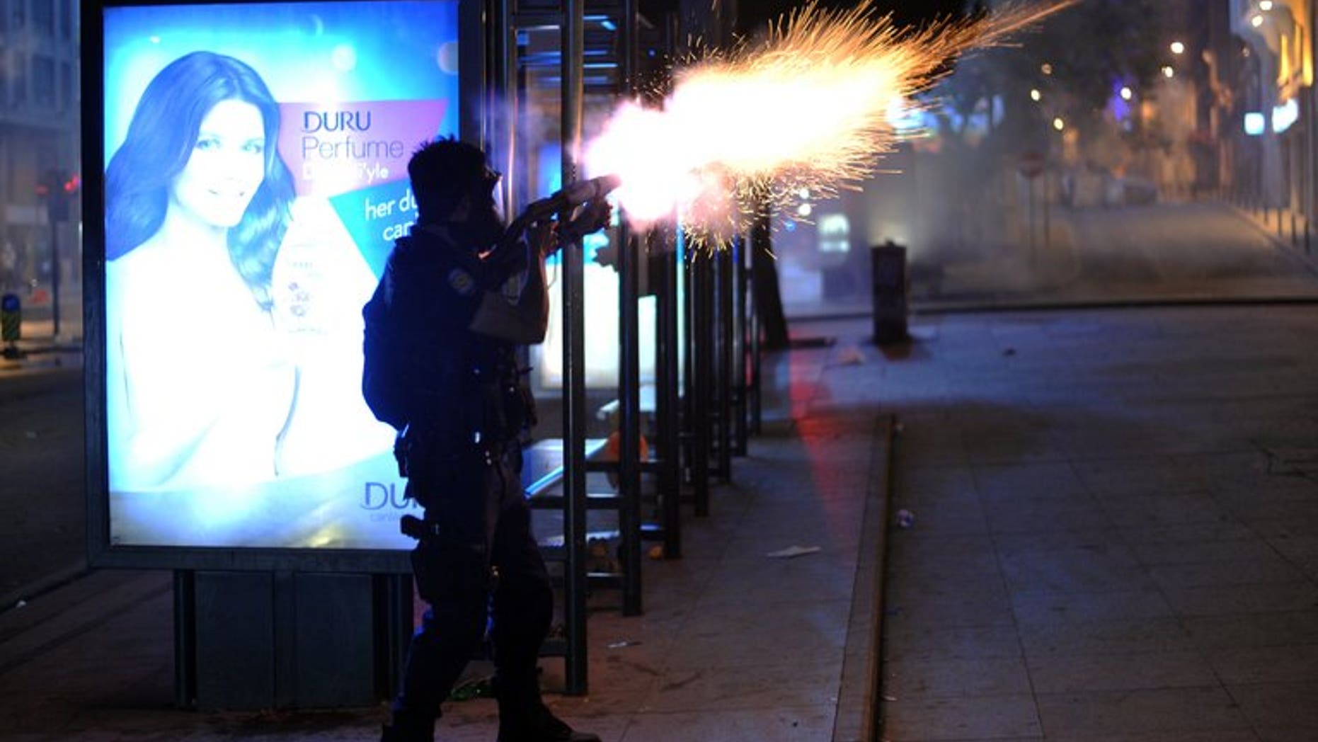 Riot police fire a tear gas bomb to disperse protesters at Harbiye near Taksim Square in Istanbul, on June 16, 2013. Turkish riot police fired tear gas and water cannon Saturday to disperse some 3,000 demonstrators who tried to enter flashpoint protest spot Taksim Square in Istanbul.