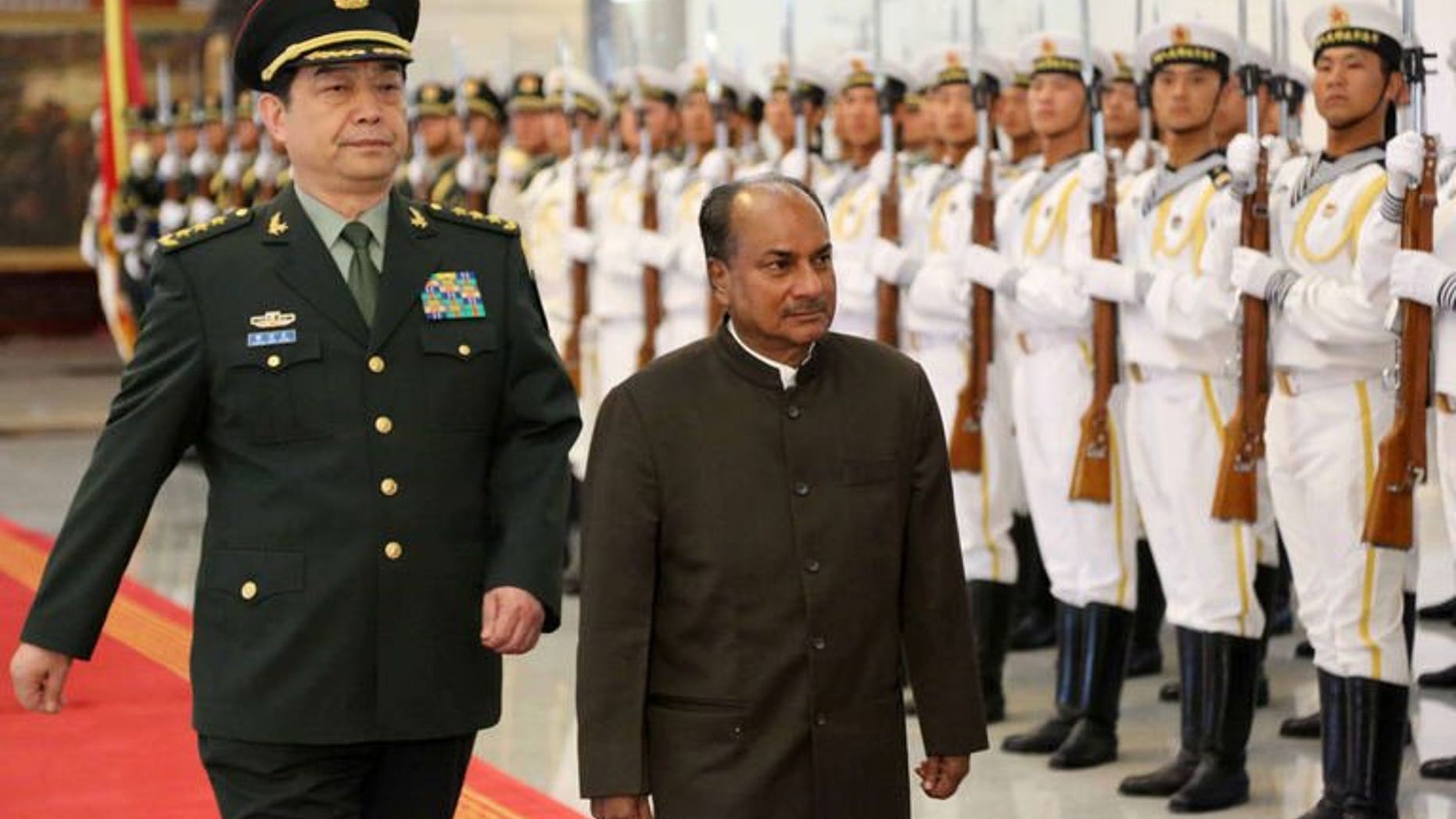 Indian Defence Minister AK Antony (R) inspects a tri-Services guard of honour with his Chinese counterpart, General Chang Wanquan in Beijing on July 5, 2013. The Chinese and Indian defence chiefs agreed Saturday to strengthen "peace and tranquility" along their frontier, state media reported, as the countries work to keep tensions in a disputed border area in check.