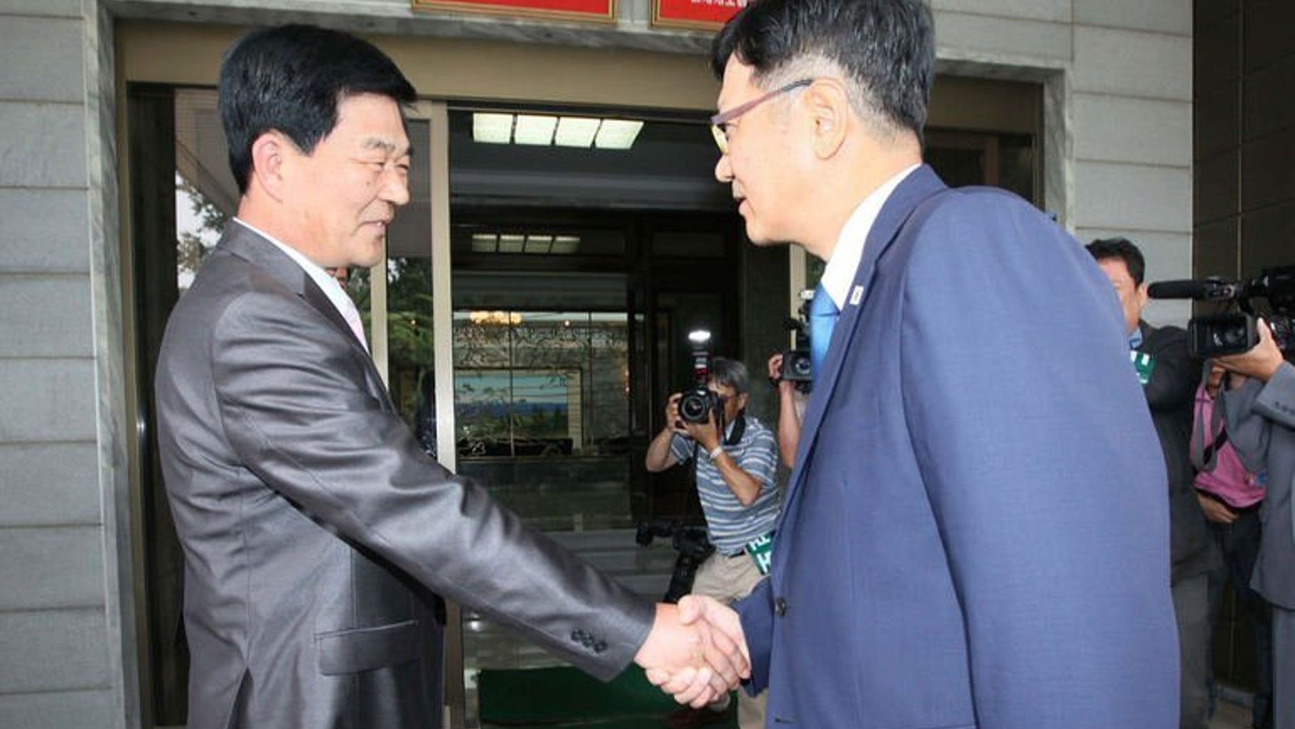 A picture released by South Korea's Unification Ministry, shows Suh Ho (R), head of the S.Korean working-level delegation, meets his N.Korean counterpart Park Chol-Su, in the truce village of Panmunjom, on July 6, 2013. North and South Korea agreed Sunday to inspect a joint industrial zone shuttered amid high cross-border tension and to hold talks on preventing another closure, reports said.