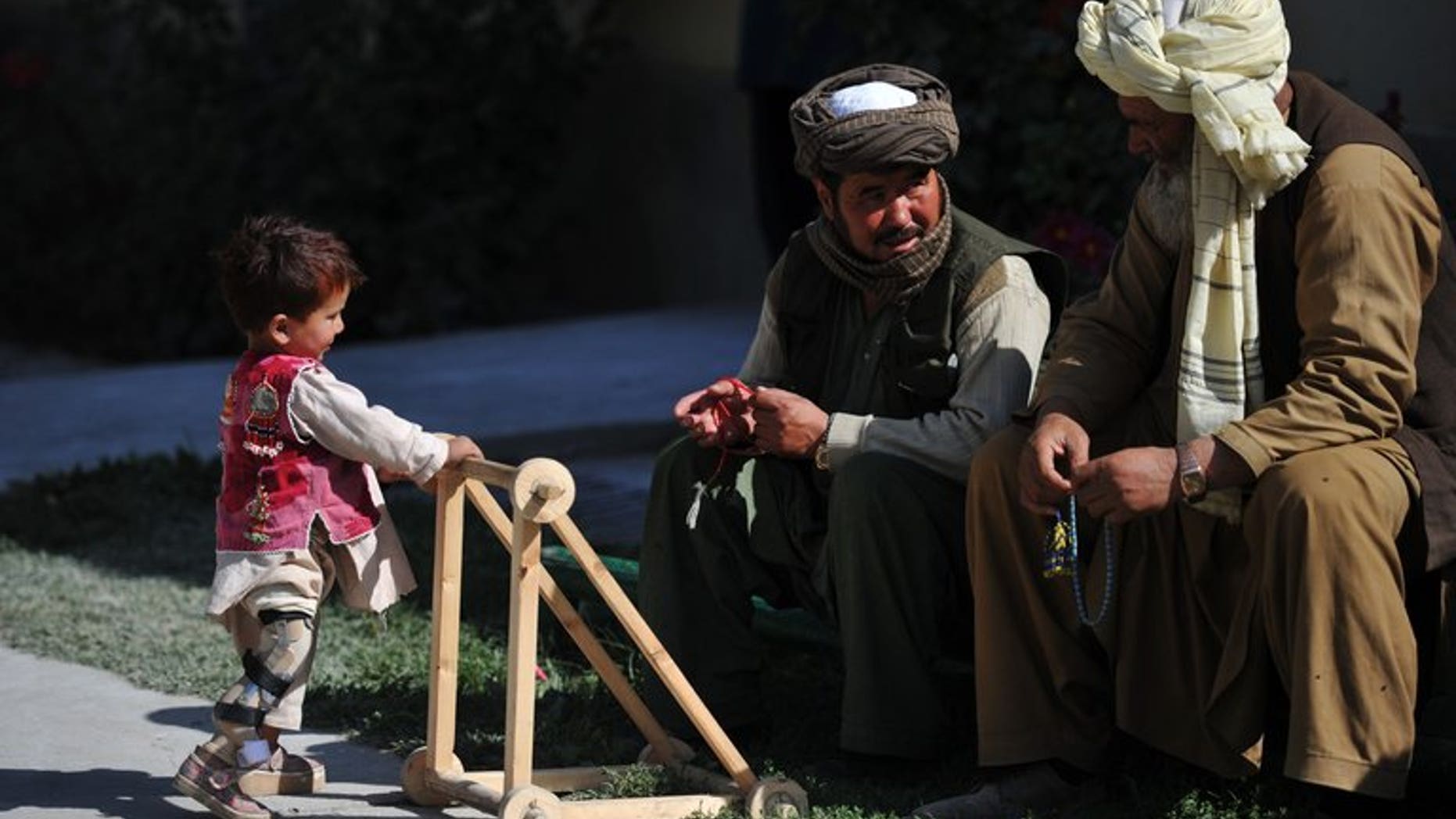 An Afghan child who lost his leg in a blast walks with a stroller at a Red Cross centre in Kabul, October 8, 2012. Norway has threatened to reduce aid to Afghanistan, signalling increasing frustration among donor nations over the Kabul government's failure to implement reforms as NATO troops prepare to withdraw.