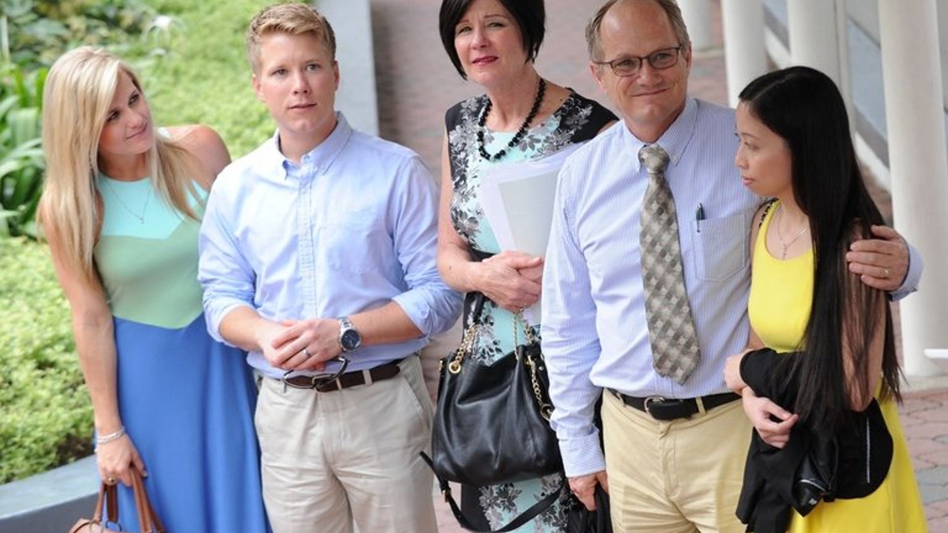 Rick Todd (2nd R), his wife Mary (C), his son Chet (2nd L) and daughter-in-law Corynne (L) and the former girlfriend of the late Shane Todd, Shirley Sarmiento (R), arrive in court in Singapore on May 14, 2013. The state coroner is set to issue the verdict Monday on the controversial death of Shane Todd, who was found hanged in the city-state and whose family believe he was murdered.