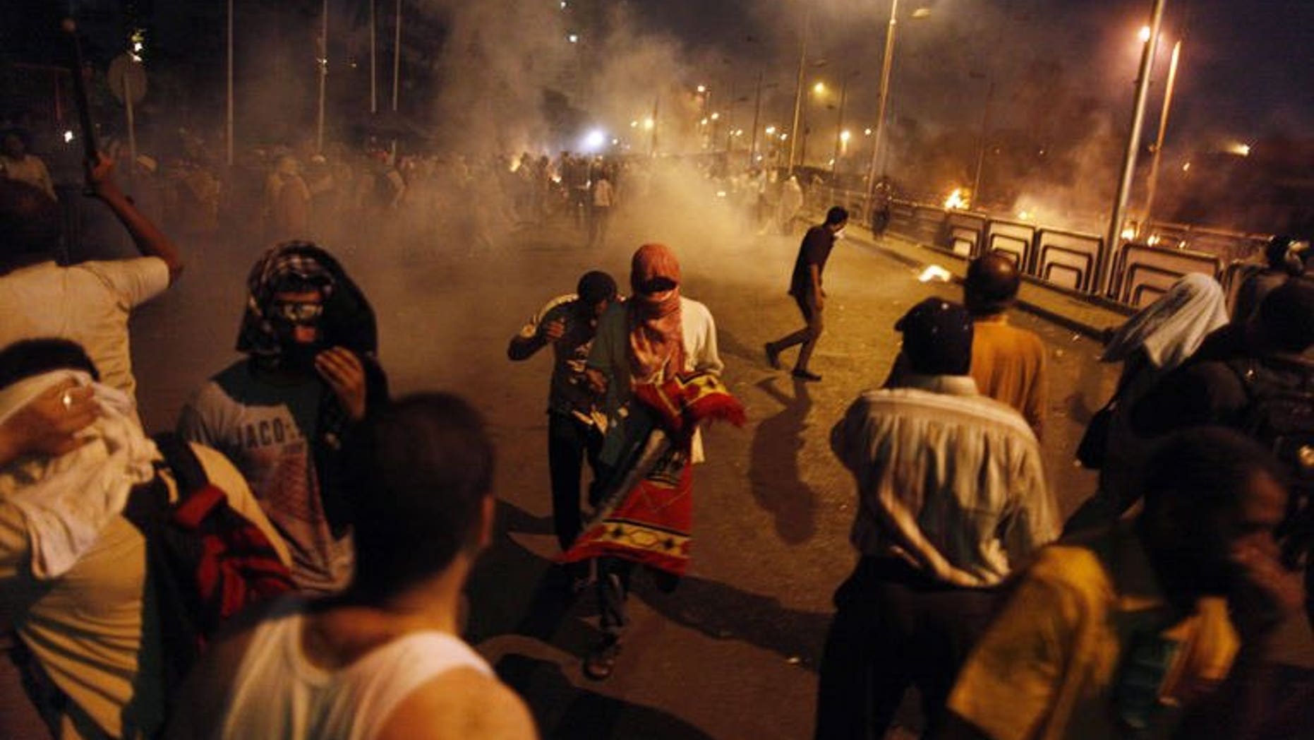 Egyptian supporters of the Muslim Brotherhood clash with police outside the elite Republican Guards base in Cairo early on July 8, 2013. The Brotherhood said on Monday that 35 supporters of ousted president Mohamed Morsi were killed at dawn when security forces opened fire on them as they were praying.