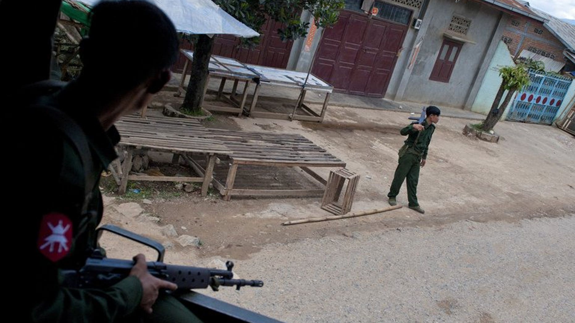Soldiers stand guard after riots broke out in Lashio, eastern Myanmar, on May 30, 2013. Myanmar has discharged 42 children and young people from its armed forces, UN agencies has said, urging increased efforts to free child soldiers as the country emerges from military rule.