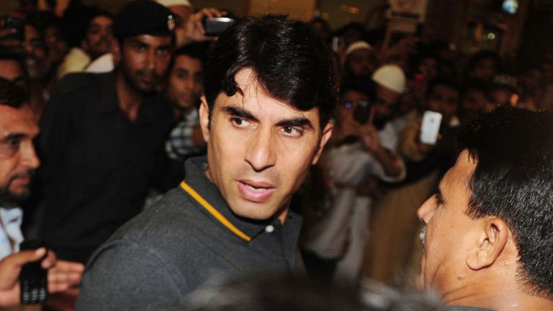 Pakistan ODI cricket captain Misbah-ul Haq (C) arrives at Karachi International Airport before his departure to the Caribbean, in Karachi on July 7, 2013. Pakistan's one-day squad left for the Caribbean with Misbah hoping to reverse the team's dwindling fortunes in the limited over matches.