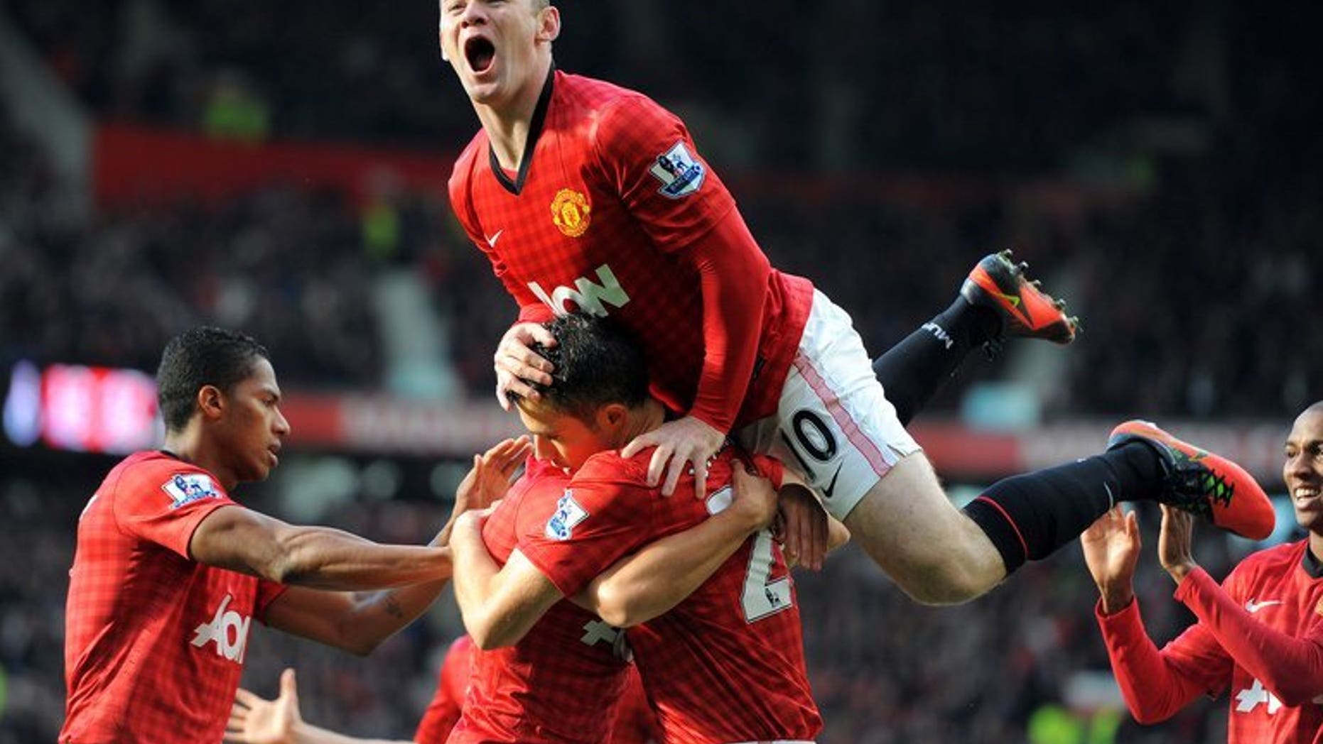 Manchester United's English forward Wayne Rooney celebrates after Dutch teammate Robin van Persie scored against Arsenal during an English Premier League game at Old Trafford in Manchester, northwest England, on November 3, 2012. English Premier League champions United on Monday announced that it had signed a five-year partnership with Russian airline Aeroflot.