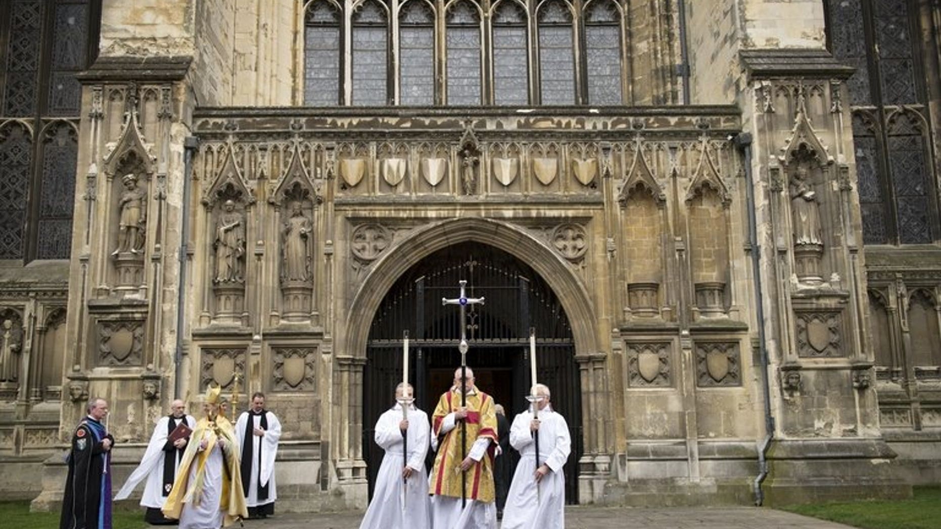 The Archbishop of Canterbury, Justin Welby (3-L) leaves from the West Door at Canterbury Cathedral on March 21, 2013. The Church of England voted Monday to restart the process that would lead to ordaining women bishops after traditionalists blocked the idea last year, plunging the church into turmoil.