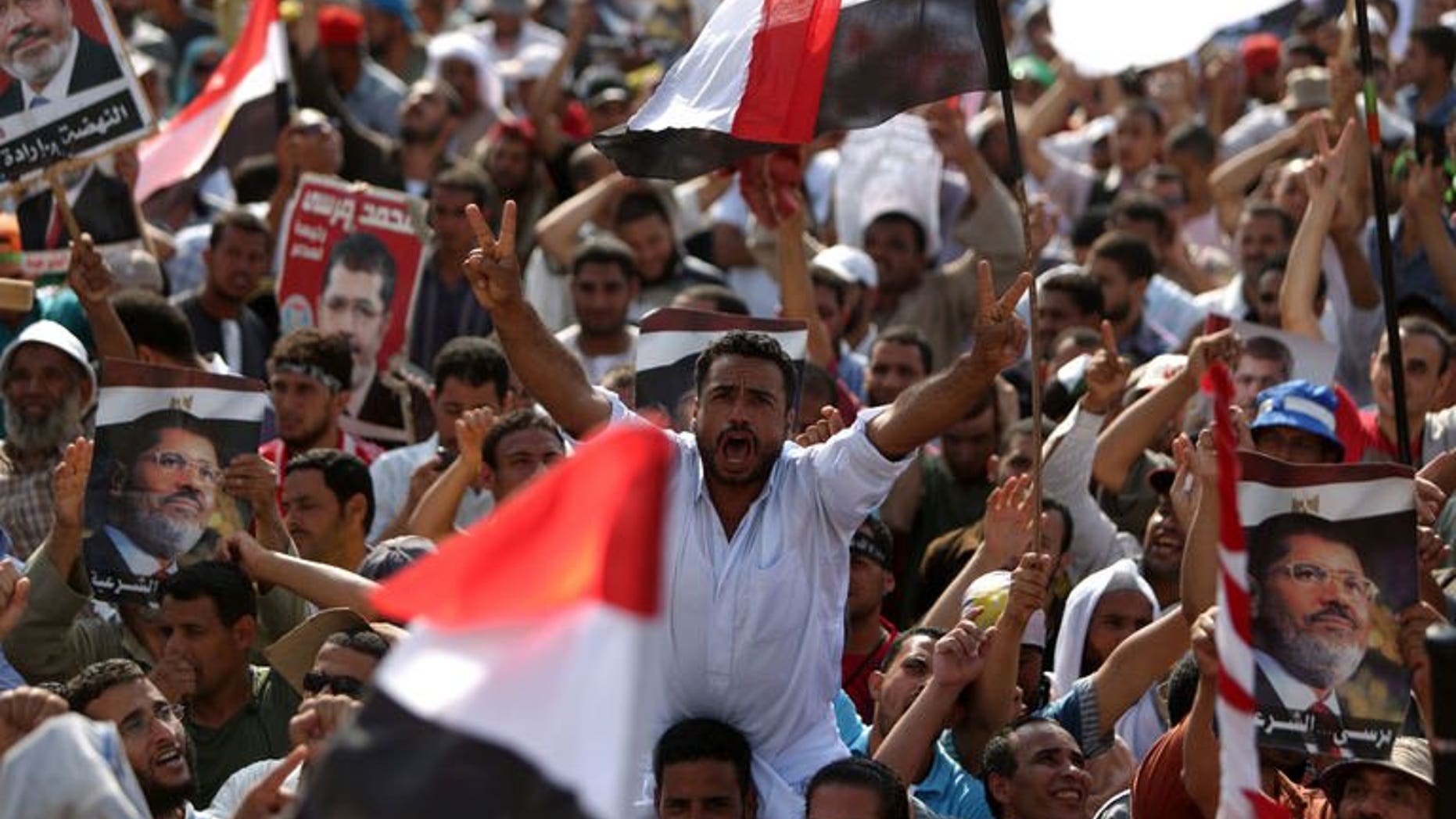 Egyptian supporters of deposed president Mohamed Morsi shout slogans during a rally outside Cairo's Rabaa al-Adawiya mosque on July 8, 2013. Morsi's Muslim Brotherhood, which has led demonstrations against Wednesday's overthrow of the Islamist leader, called for an "uprising," saying troops and police "massacred" its supporters during dawn prayers in Cairo Monday.