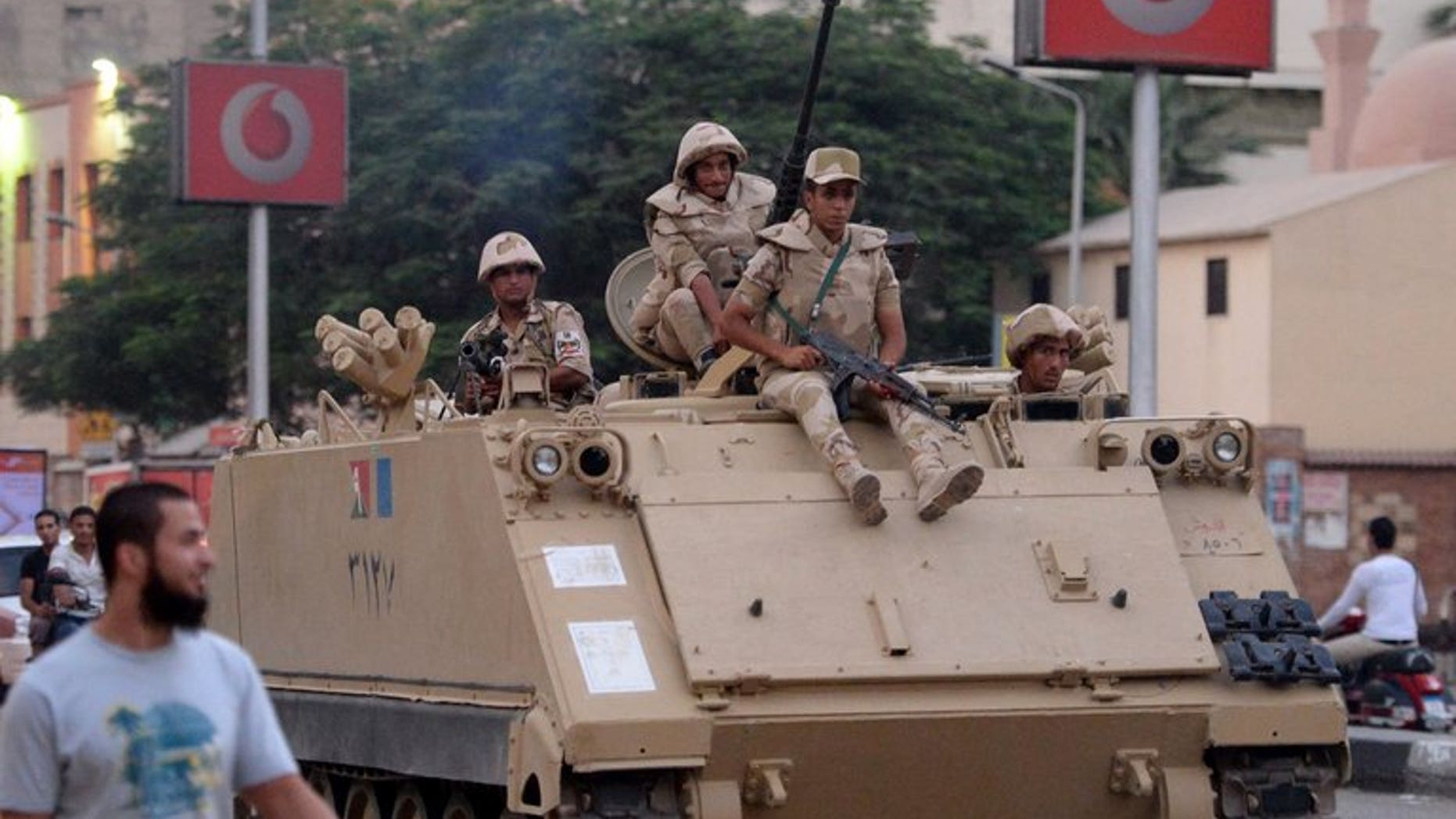 Egyptian army soldiers sit on top of an armoured personnel carrier in a Cairo street on July 3, 2013. Israel has urged Washington not to suspend its annual $1.3 billion in aid to Cairo in the wake of the ouster of Egyptian president Mohamed Morsi by the military, press reports said.