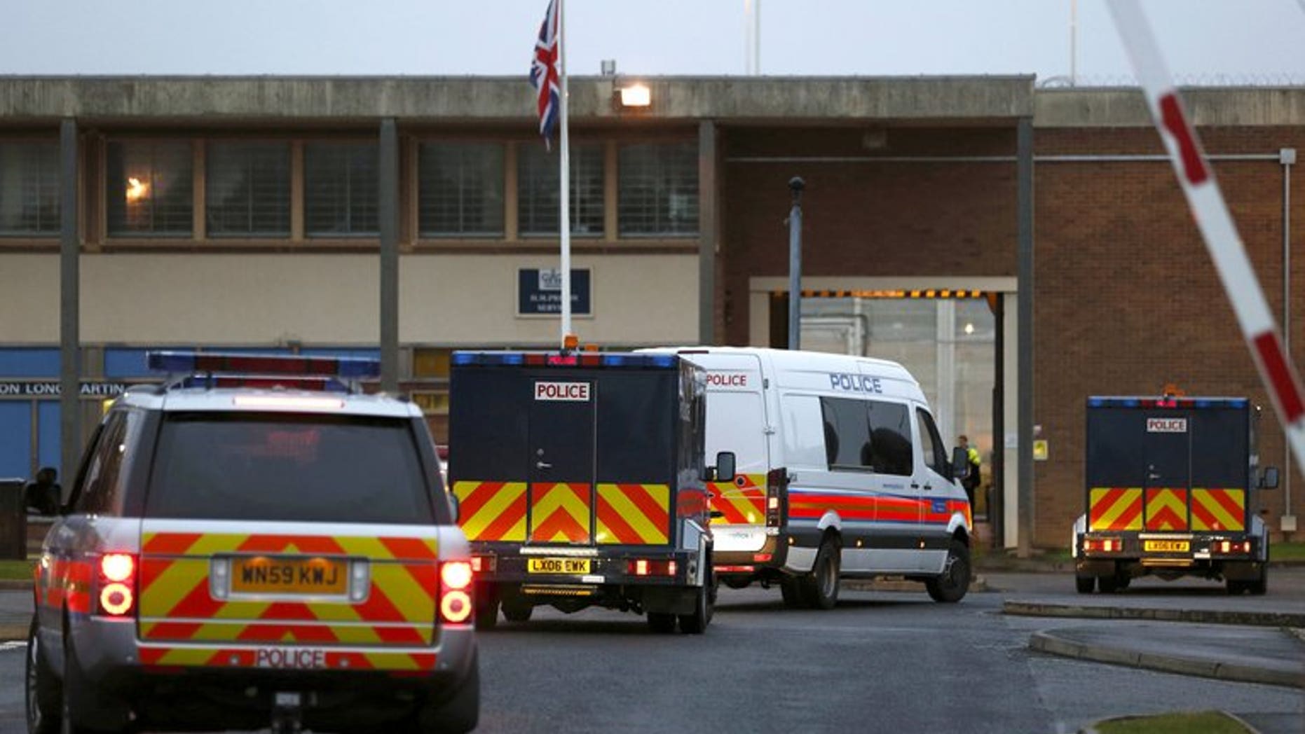 A police motorcade, including armoured vehicles, arrives at Long Lartin prison in central England, on October 5, 2012. Europe's rights court on Tuesday ruled that whole-life prison terms imposed in Britain amounted to "inhuman and degrading" treatment, in a case brought by three of the country's most notorious murderers.