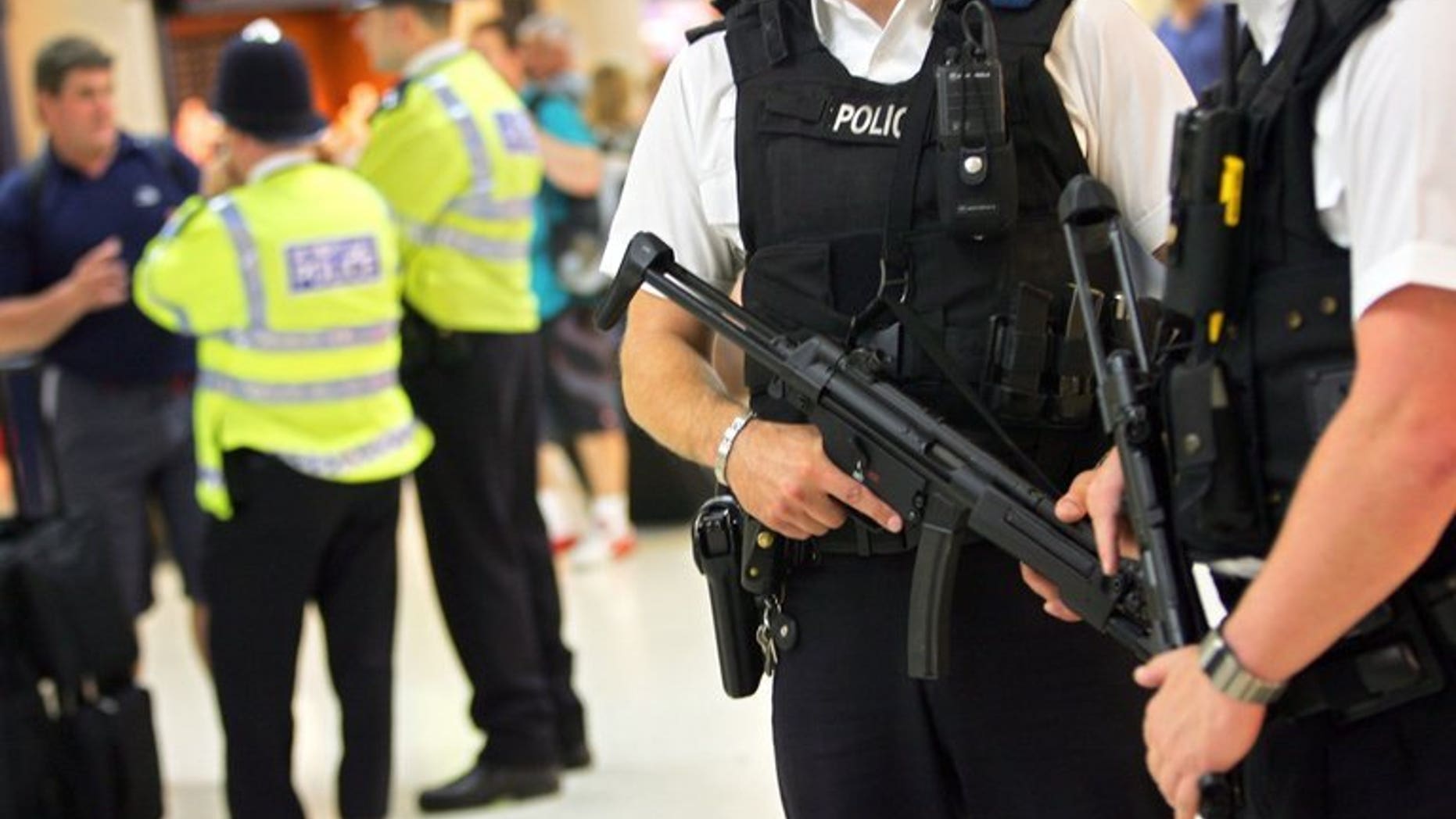 Armed police officers patrol in London on August 2, 2005. A man believed to be armed is holding a two-year-old girl at a house in Kidlington, Oxford, police said on Tuesday.