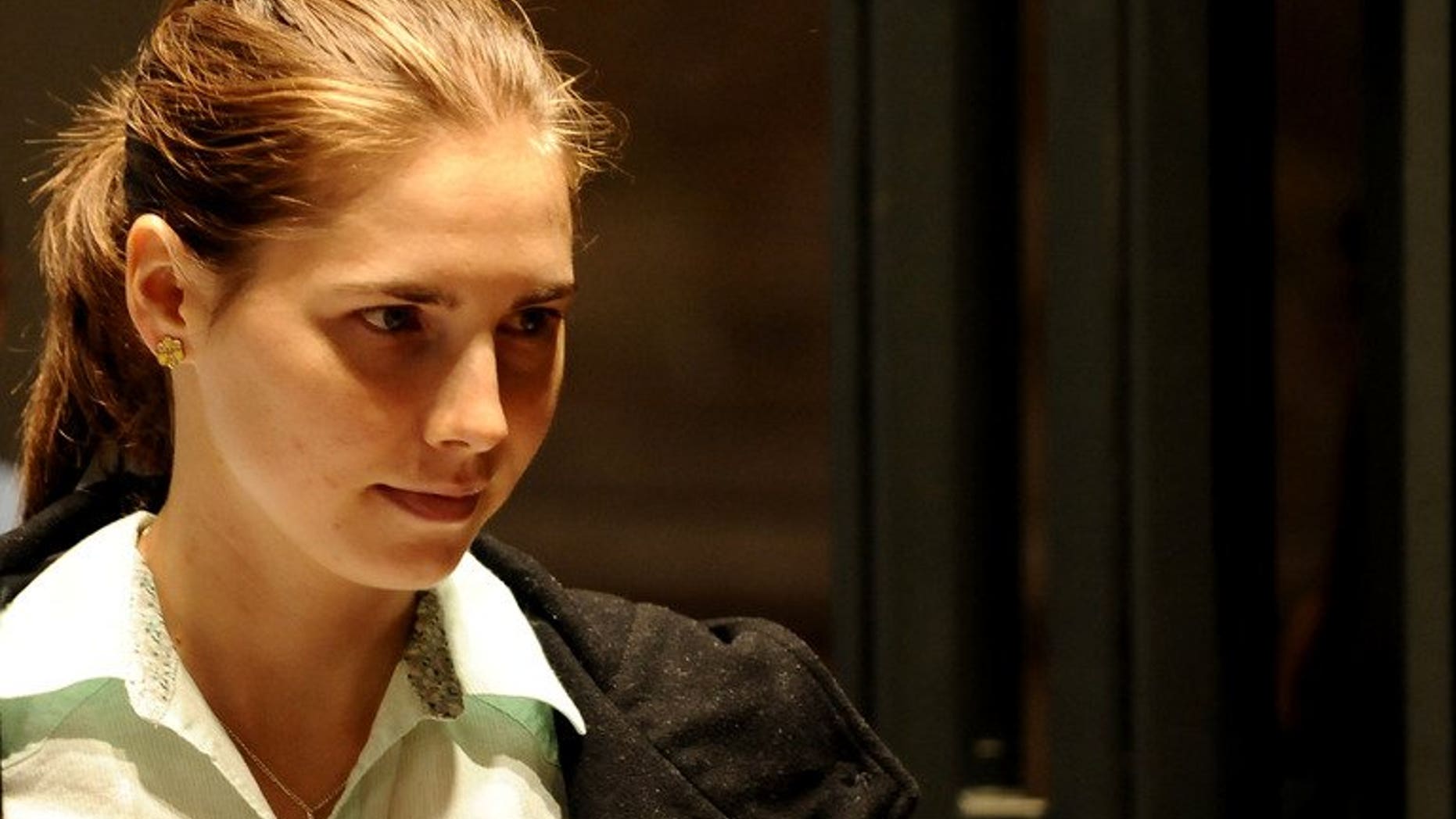 Amanda Knox is escorted into a Perugia courthouse during her appeal trial on September 24, 2011. An appeal trial over the murder of a British student in Italy is to begin on September 30 after Italy's top court overturned the acquittal of Knox and her former Italian boyfriend Raffaele Sollecito.