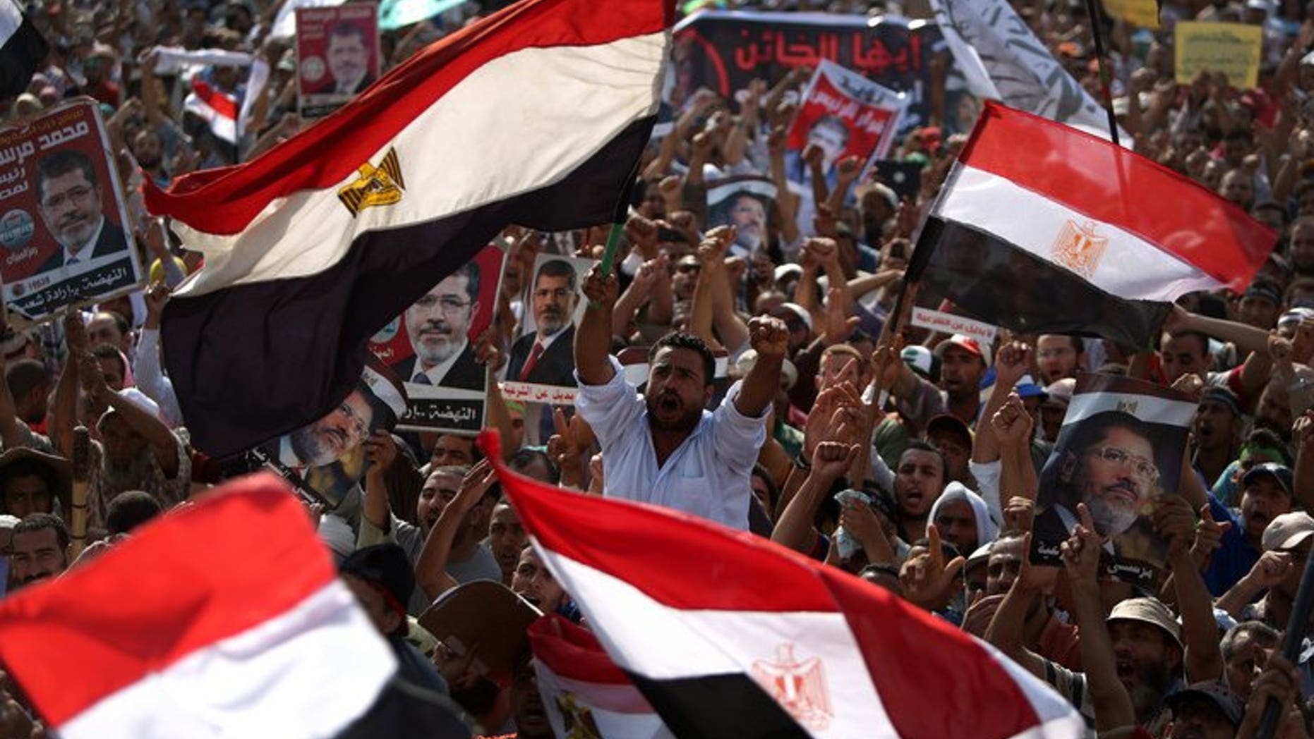 Egyptian supporters of deposed president Mohamed Morsi wave their national flag as they attend a rally in support of the former Islamist leader outside Cairo's Rabaa al-Adawiya mosque on July 8, 2013. The United Arab Emirates said it has offered Egypt an aid package of $3 billion, just days after it hailed the ouster of Islamist president Mohamed Morsi by the Egyptian army.