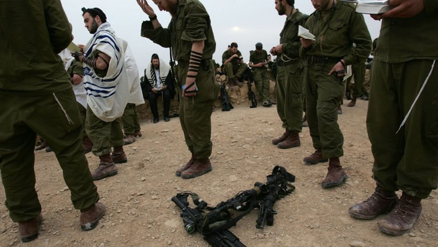 Israeli soldiers from an Ultra Orthodox battalion pray on the top of the ancient fortress of Masada in the Judean desert on March 23, 2007. Israeli police on Tuesday rescued an ultra-Orthodox soldier who was attacked by a group of his coreligionists in Jerusalem's Mea Shearim neighbourhood, a spokesman said.