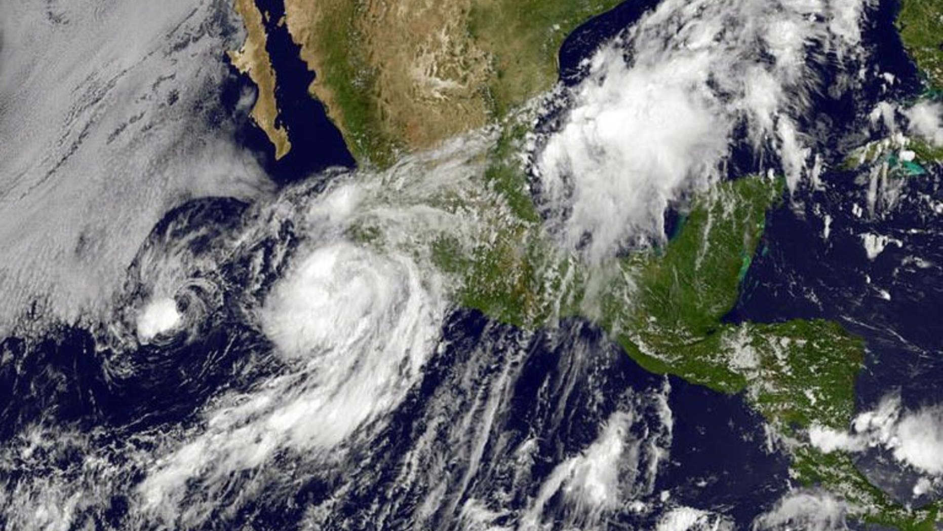 An image obtained from NOAA shows then-Hurricane Erick moving up the western coast of Mexico on July 6, 2013. At least two people died and two more remained missing after the tropical storm grazed Mexico's Pacific coast before weakening into a tropical depression, authorities said Tuesday.