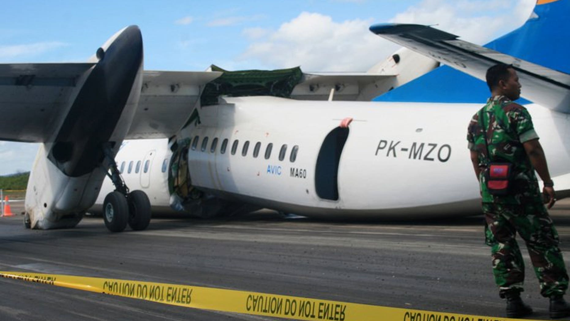 An Indonesian soldier stands guard next to an MA60 Merpati Airlines plane after it crash-landed in Kupang on June 10, 2013. New Zealand said it had suspended a multi-million-dollar aid programme in Tonga over safety concerns stemming from the Pacific nation's plans to use the Chinese-made plane for domestic services.