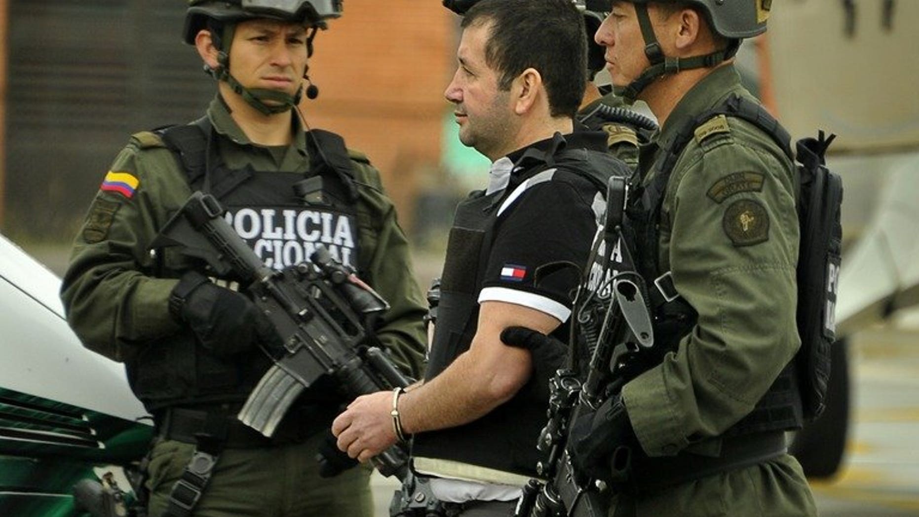 Colombian drug trafficker Daniel "El Loco" Barrera is escorted by police on July 9, 2013 in Bogota. The last of the major Colombian drug lords, Barrera, was extradited to the United States, where there had been a $5 million reward for his capture, Colombian police said.