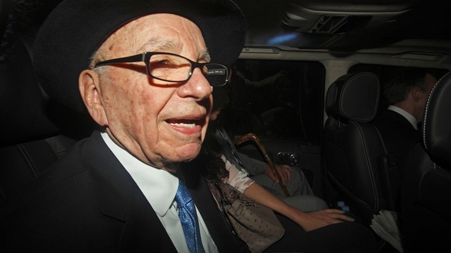 Rupert Murdoch is seen in a car in central London on April 26, 2012. MPs have recalled Murdoch to testify after a tape recording emerged of the media tycoon slamming the police investigation into alleged phone hacking and bribery by his journalists.