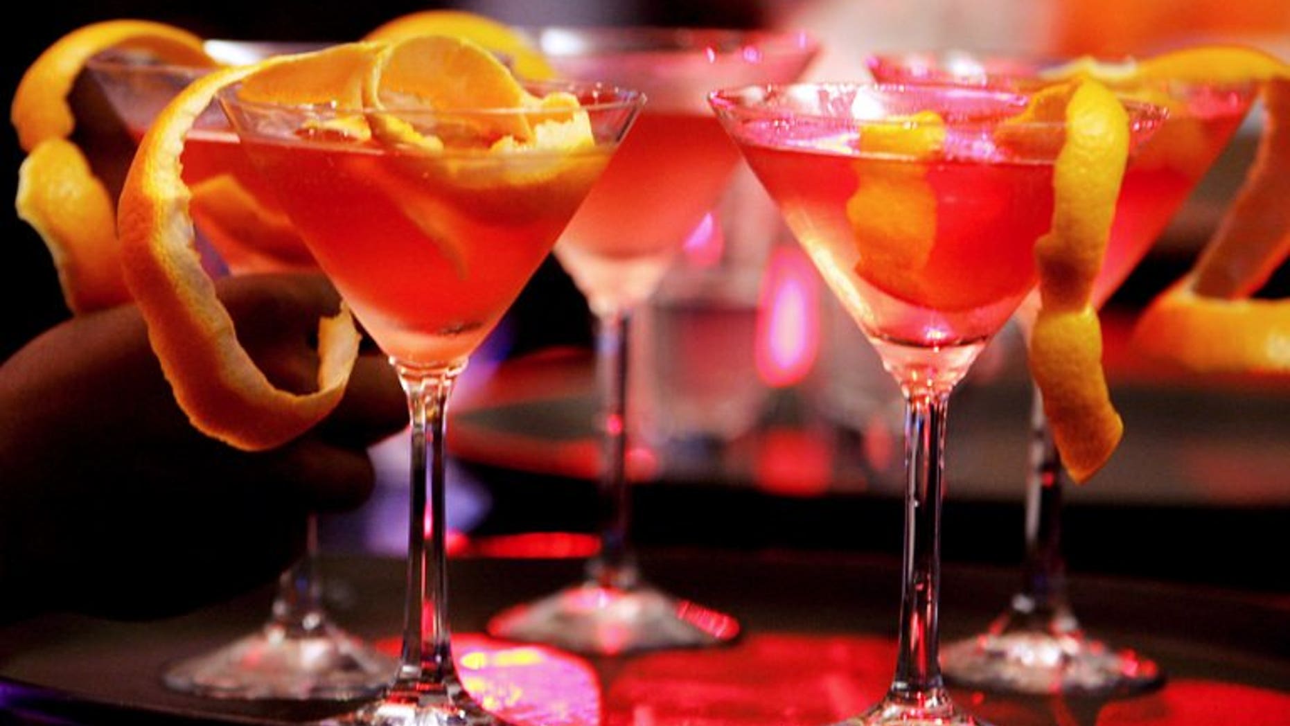 Bar waitresses prepare cocktails at a bar in Bangalore, on May 30, 2007. Women hired as bartenders in the southeastern Indian IT hub of Bangalore must wear "decent" clothes including long-sleeved shirts and trousers, according to new state government guidelines approved by a top court.