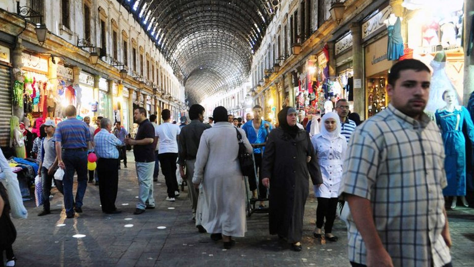 Syrians shop in the covered market in central Damascus on July 9, 2013 as they prepare for the Muslim holy fasting month of Ramadan. The new leader of Syria's opposition National Coalition called on Wednesday for international pressure on President Bashar al-Assad to accept a truce in the central city of Homs for the Muslim fasting month of Ramadan.