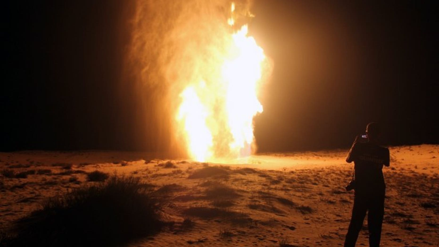 An Egyptian stands in front of a gas pipeline on July 22, 2012, which was blown up by attackers in Egypt's northern Sinai. Energy-poor Jordan said on Wednesday that gas supplies from Egypt will resume within 10 days following sabotage on Sunday to the export pipeline by militants in the Sinai Peninsula.