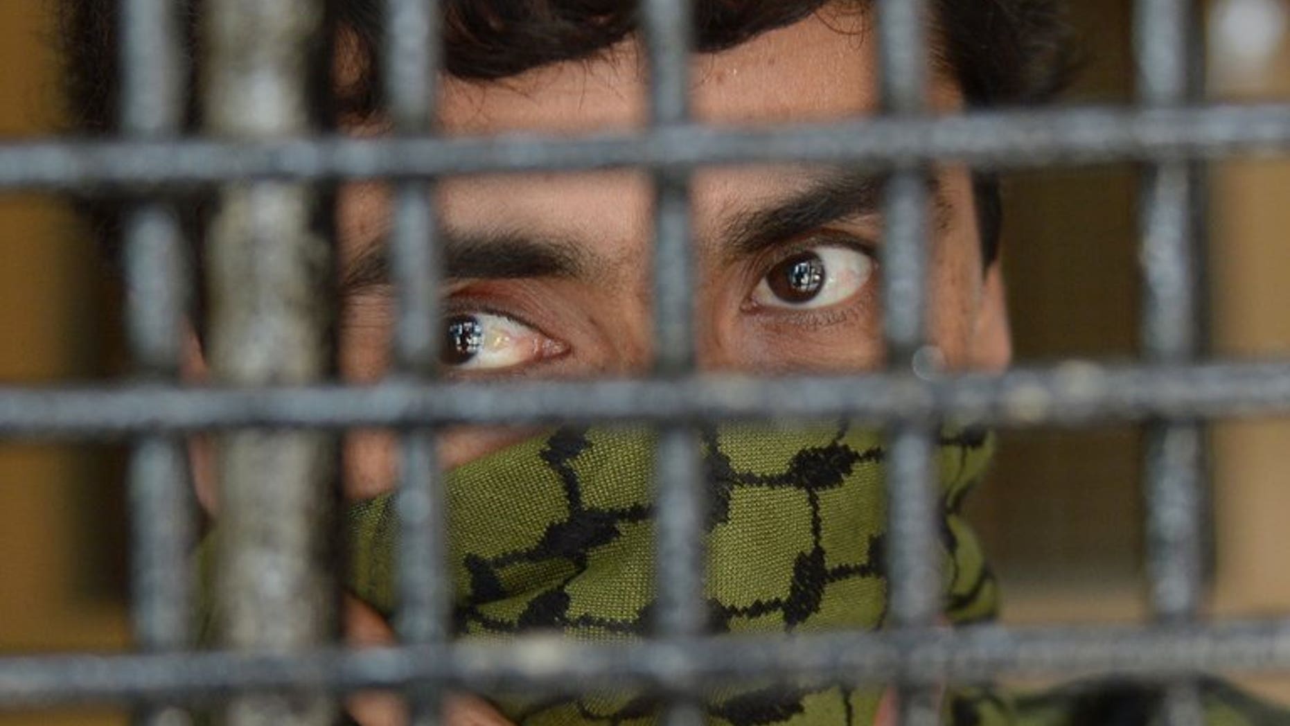 Sayeed Abbas waits inside a detention room prior to his trial in Jakarta, on July 11, 2013. The court has rejected a request for the extradition of the alleged people-smuggling "kingpin" to Australia, instead freeing the Afghan from detention.