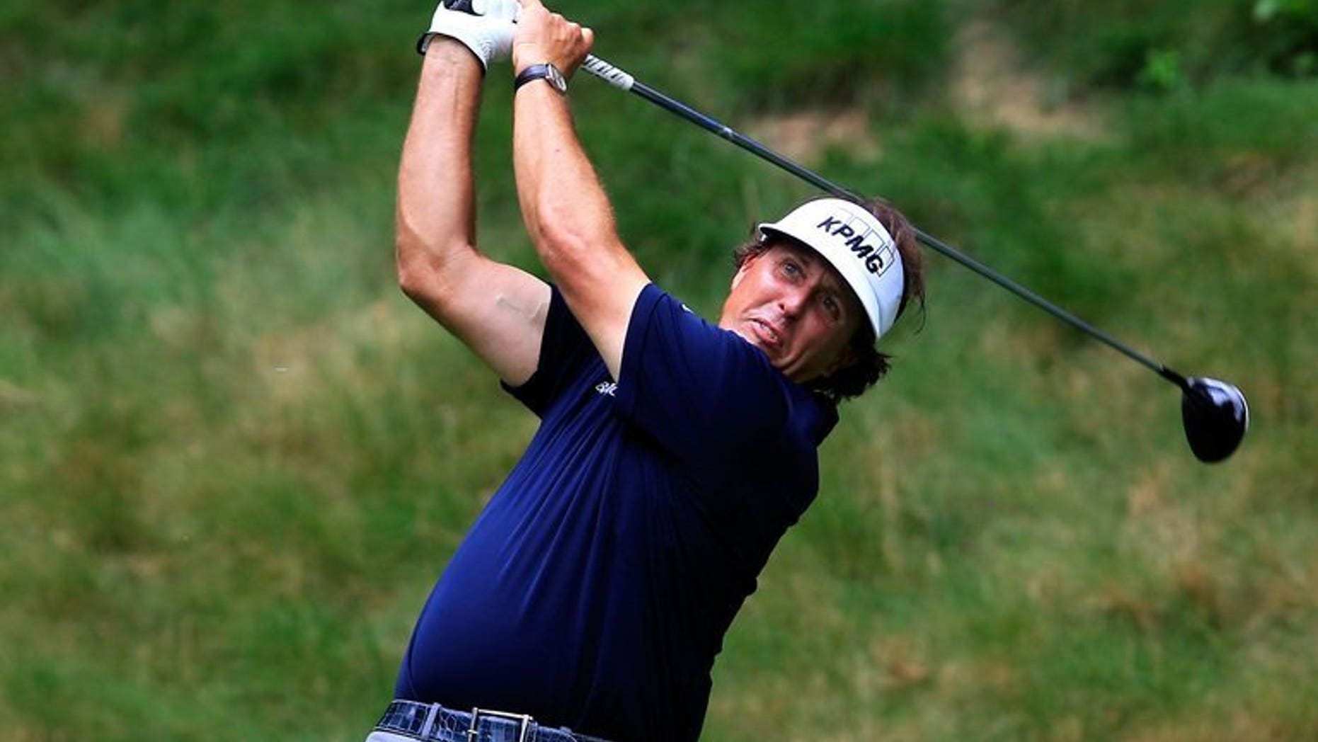 File image shows Phil Mickelson watching his tee shot on the seventh hole during round one of the Greenbrier Classic at the Old White TPC on July 4, 2013 in White Sulphur Springs, West Virginia. Mickelson made the most of near benign conditions to post a six-under-par 66 early on the opening day of the Scottish Open near Inverness.
