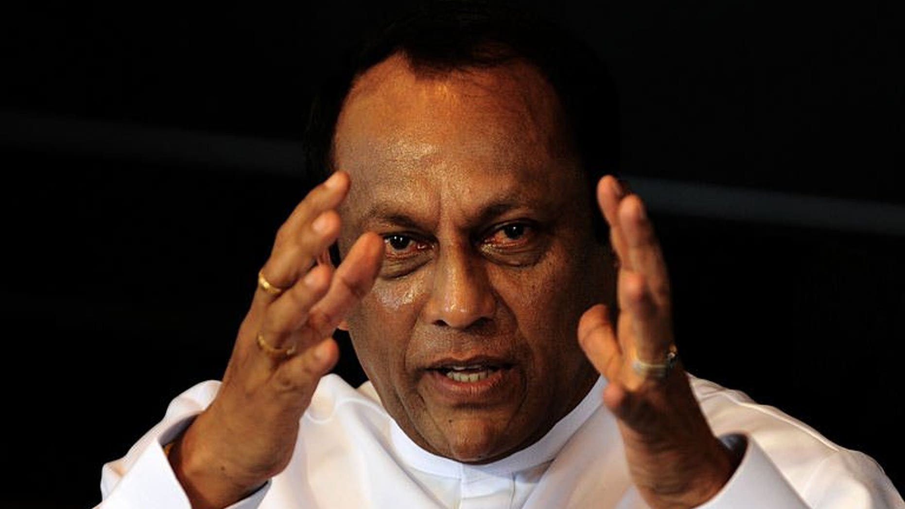 Sri Lanka's Investment Promotion Minister Lakshman Yapa Abeywardena speaks to reporters in Colombo on July 11, 2013. Sri Lanka's hotels are overcharging for rooms in an attempt to cash in on growing visitor numbers after a decades-long war, Abeywardena said.