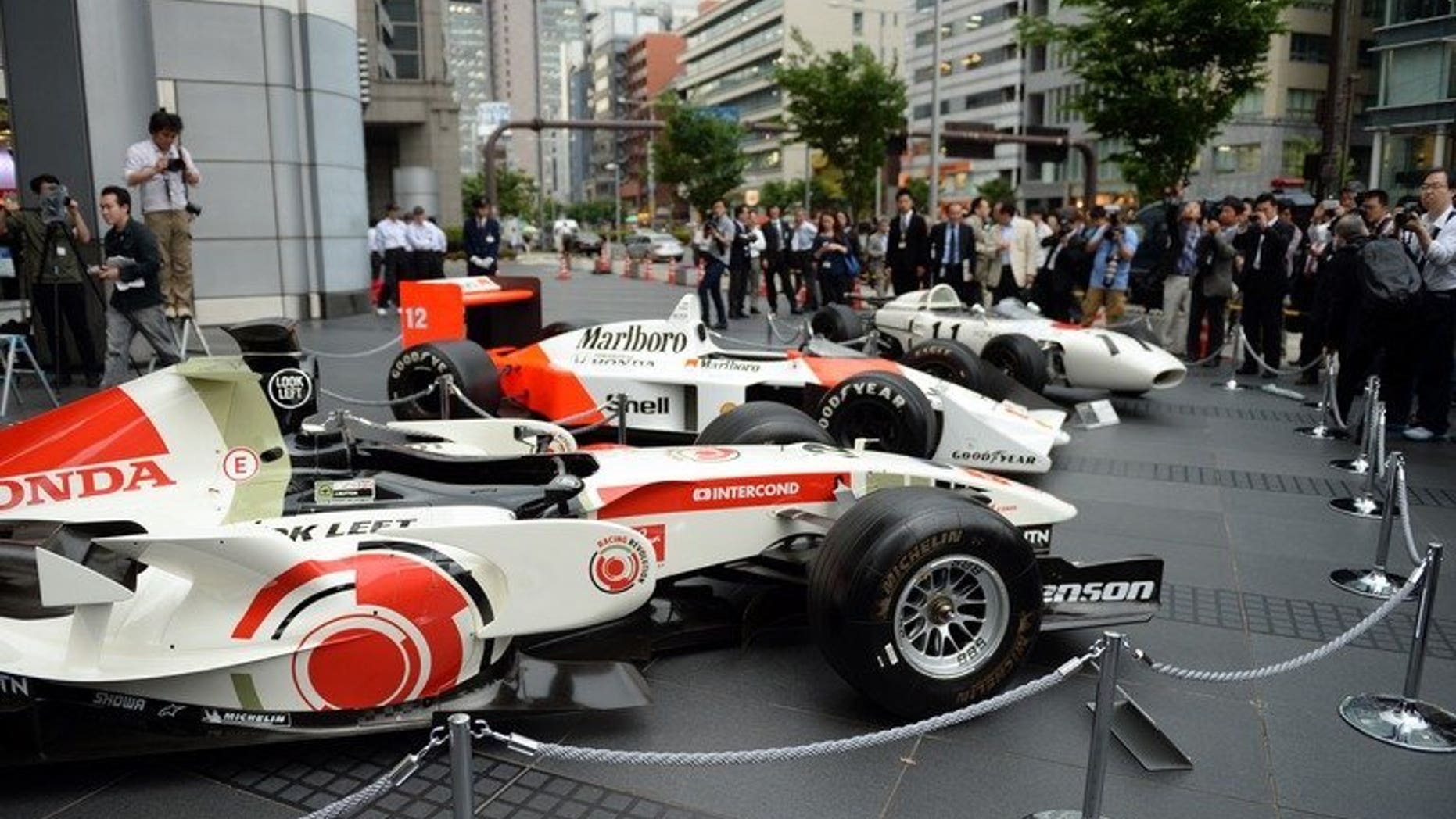 Three generations of Honda Formula One cars on display in Tokyo on May 16, 2013. The Japanese automaker said it will build a European racing operations base in Britain ahead of its return to the sport in 2015.