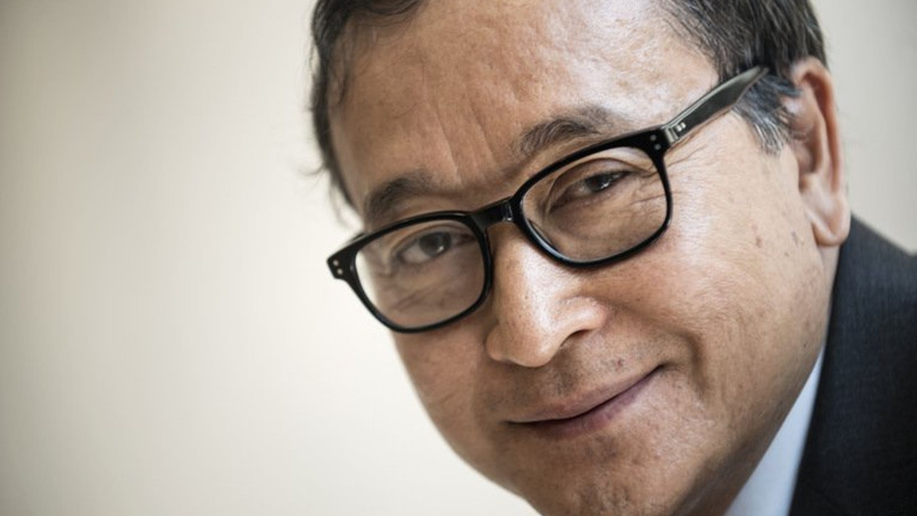 Cambodia's opposition leader Sam Rainsy poses for a portrait on May 9, 2013 during a visit to Washington DC. Rainsy has been pardoned by the king, according to a royal decree seen by AFP, clearing the way for his return ahead of national elections.