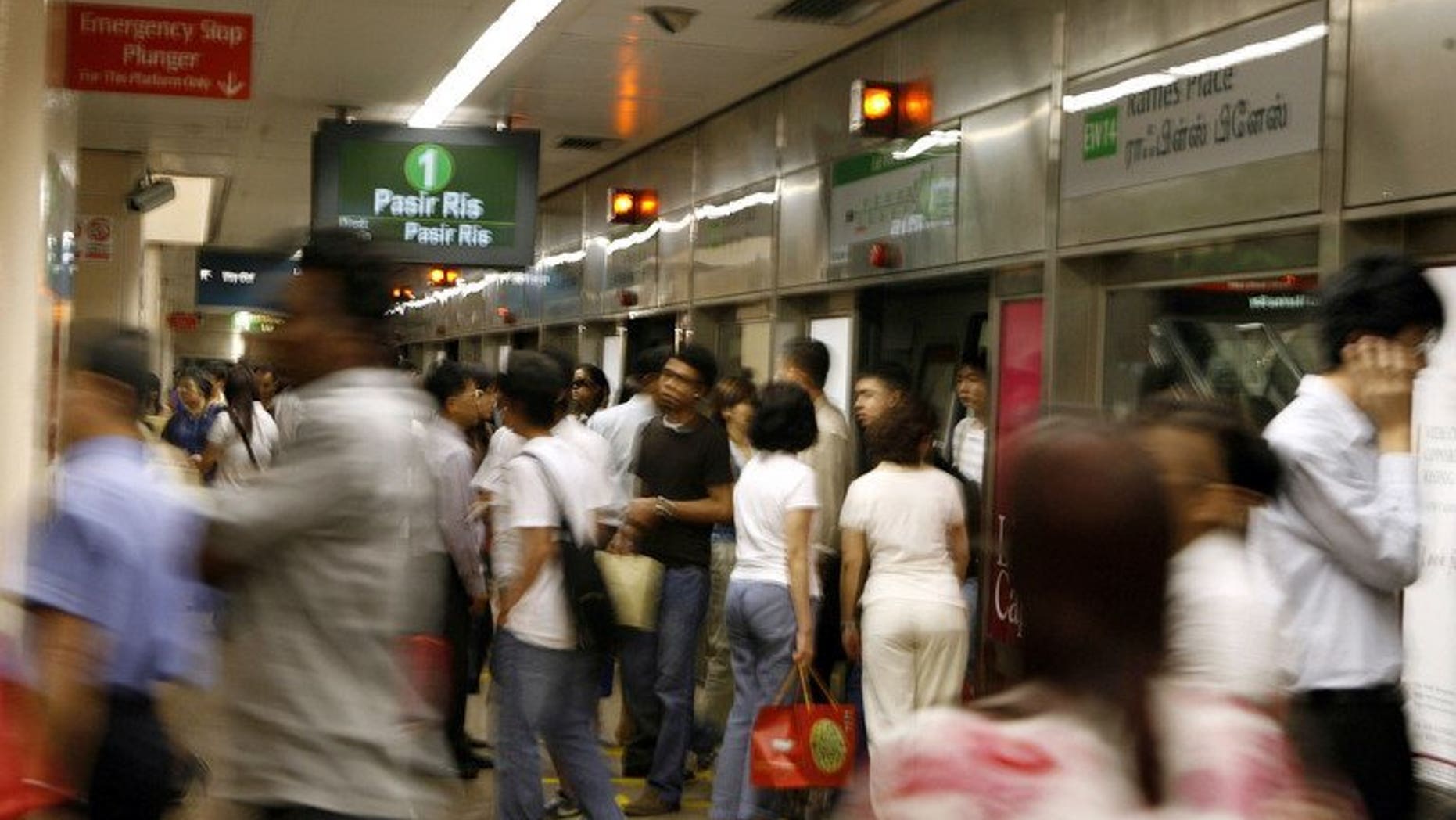 People get on and off a subway train at an MRT metro station in Singapore, February 15, 2007. Suicides in Singapore hit an all-time high of 487 in 2012 as more young people bogged down by stress and relationship woes took their own lives, a charity group dealing with the problem said Friday.