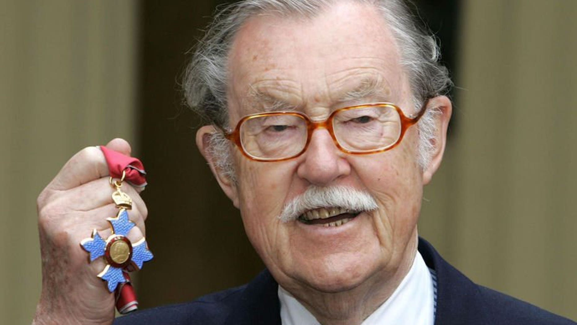 Presenter Alan Wicker poses with his CBE after receiving the honour at Buckingham Palace on March 22, 2005. The travel broadcaster, the consummate gentleman abroad during more than six decades on television, has died, aged 87.
