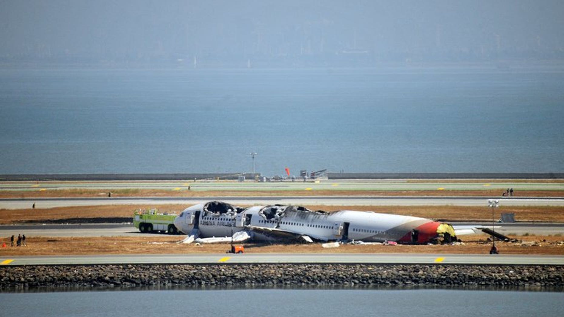 Investigators continue to inspect the scene of an Asiana Airlines Boeing 777 at San Francisco International Airport on July 7, 2013. South Korean aviation officials on Friday dismissed any suggestion that a deferential culture in which junior pilots were afraid to challenge their seniors played a part in the crash of an Asiana jet in San Francisco.