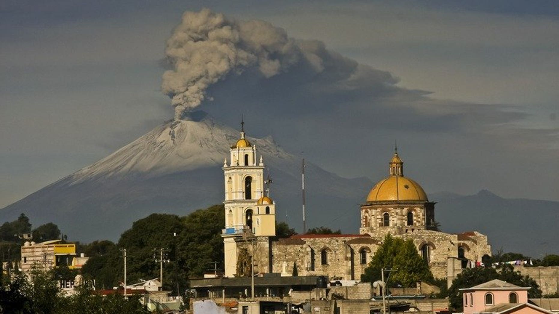 Ash spews from Mexico's Popocatepetl volcano, some 55 km from Mexico City, as seen from San Damian Texoloc in the Mexican central state of Tlaxcala, on July 9, 2013. A handful of US flights were canceled at two Mexican airports on Friday after ash from a nearby volcano fell in central Mexico, authorities said.