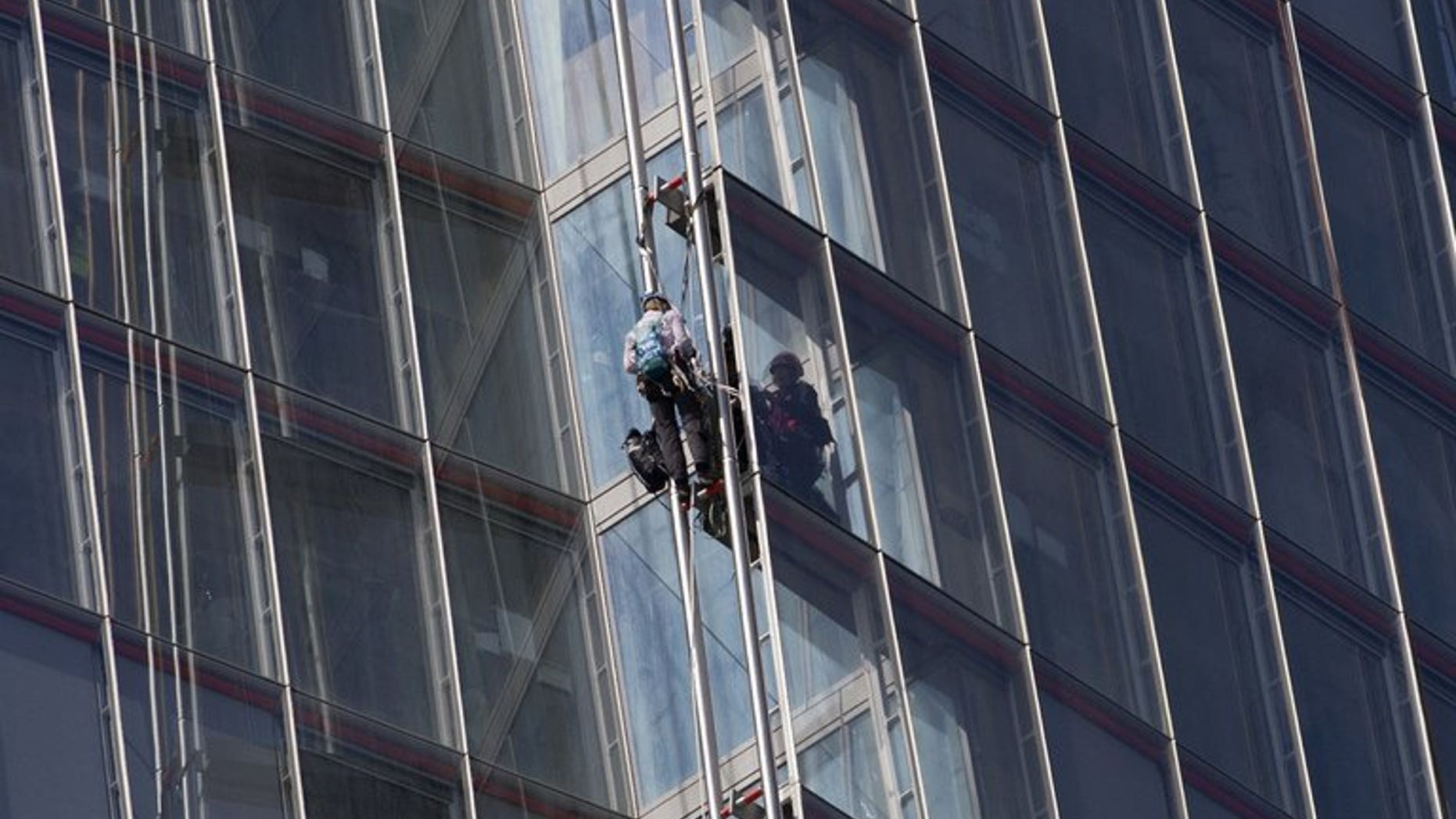 Greenpeace protesters climb "The Shard" skyscraper in central London on July 11, 2013 during a demonstration against oil exploration in the Arctic.