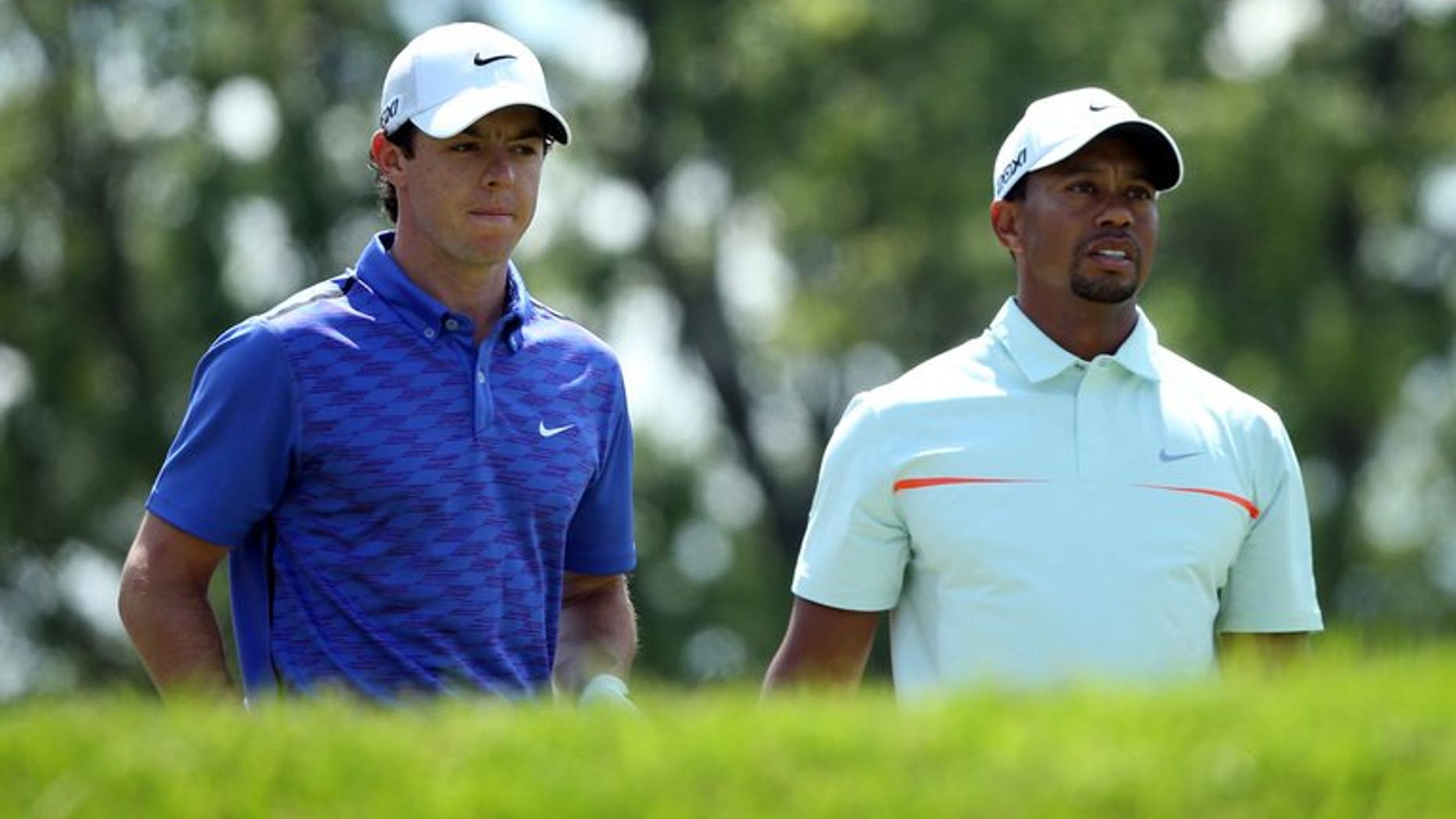 Rory McIlroy of Northern Ireland (L) and Tiger Woods of the US, pictured during the 113th US Open, at Merion Golf Club in Ardmore, Pennsylvania, on June 15, 2013. Woods and McIlroy will go head-to-head in a two-man exhibition for the second time in China following last year's outlandish Duel at Jinsha Lake, organisers announced on Saturday.