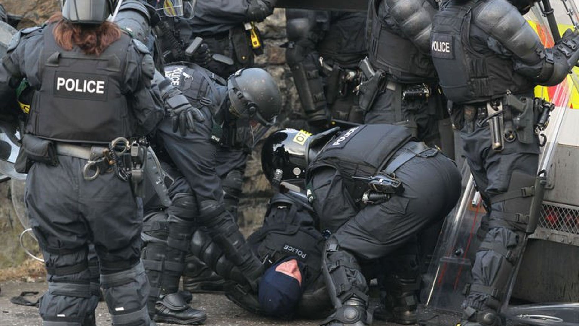An injured policeman is carried away during clashes with Orangemen protesters in north Belfast, Northern Ireland, on July 12, 2013. Hundreds of extra police have been deployed to Northern Ireland following a night of rioting in Belfast that left 32 officers injured and a politician hospitalised.
