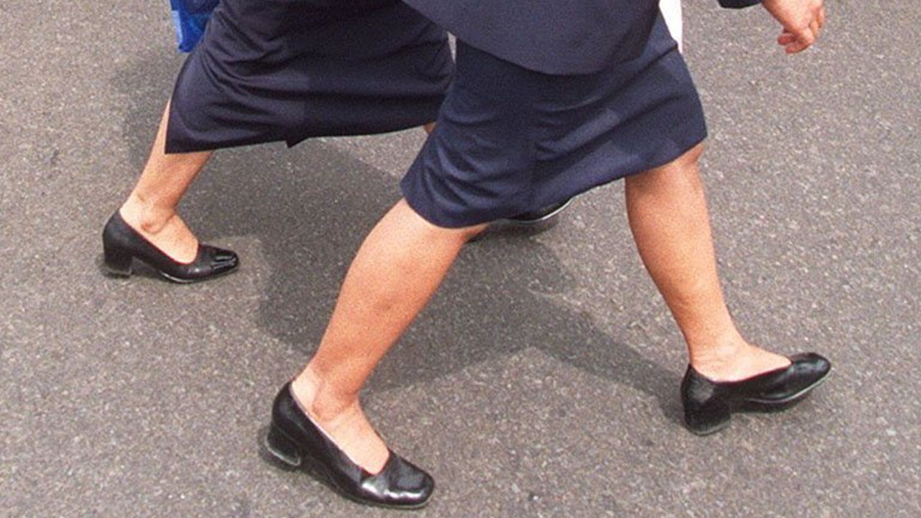Two Indonesian secretaries walk through the centre of Jakarta. The governor of an Indonesian province has ordered his top staff to replace their female secretaries with men following a string of extra-marital affairs.