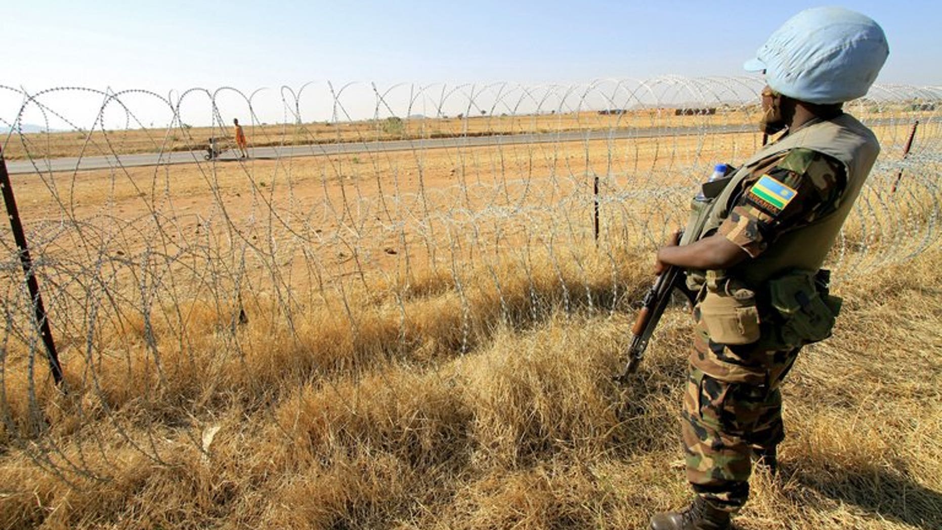 A peacekeeper serving with the joint United Nations-African Mission in Darfur (UNAMID) stands guard in a field in Zalingei in western Darfur on December 1, 2010. Seven peacekeepers have been killed in Sudan's Darfur region, the African Union-UN Mission said on Saturday, the worst-ever losses in the five-year history of the operation.