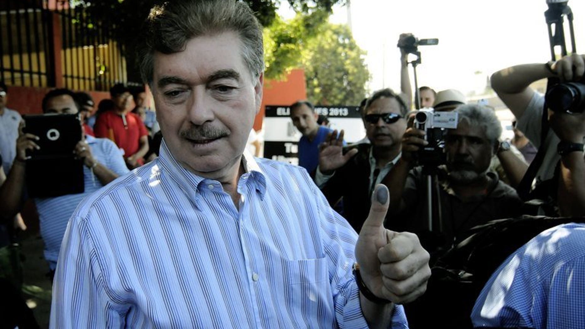 Baja California's candidate for governor Francisco Vega, shows his inked thumb after casting his vote in Tijuana, Baja California, on July 7, 2013. Mexico's conservative opposition retained the governor's seat in Baja California after the ruling party candidate conceded defeat Saturday following a recount in the politically crucial state.