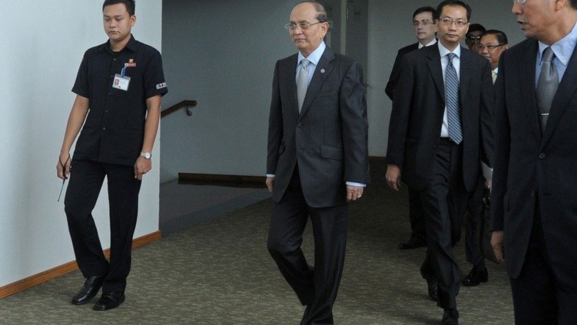 Myanmar President Thein Sein (C) arrives at Yangon International airport before departing for a visit to Britain and France, on July 14, 2013. The former junta general looks to build on support for his much-lauded reforms.